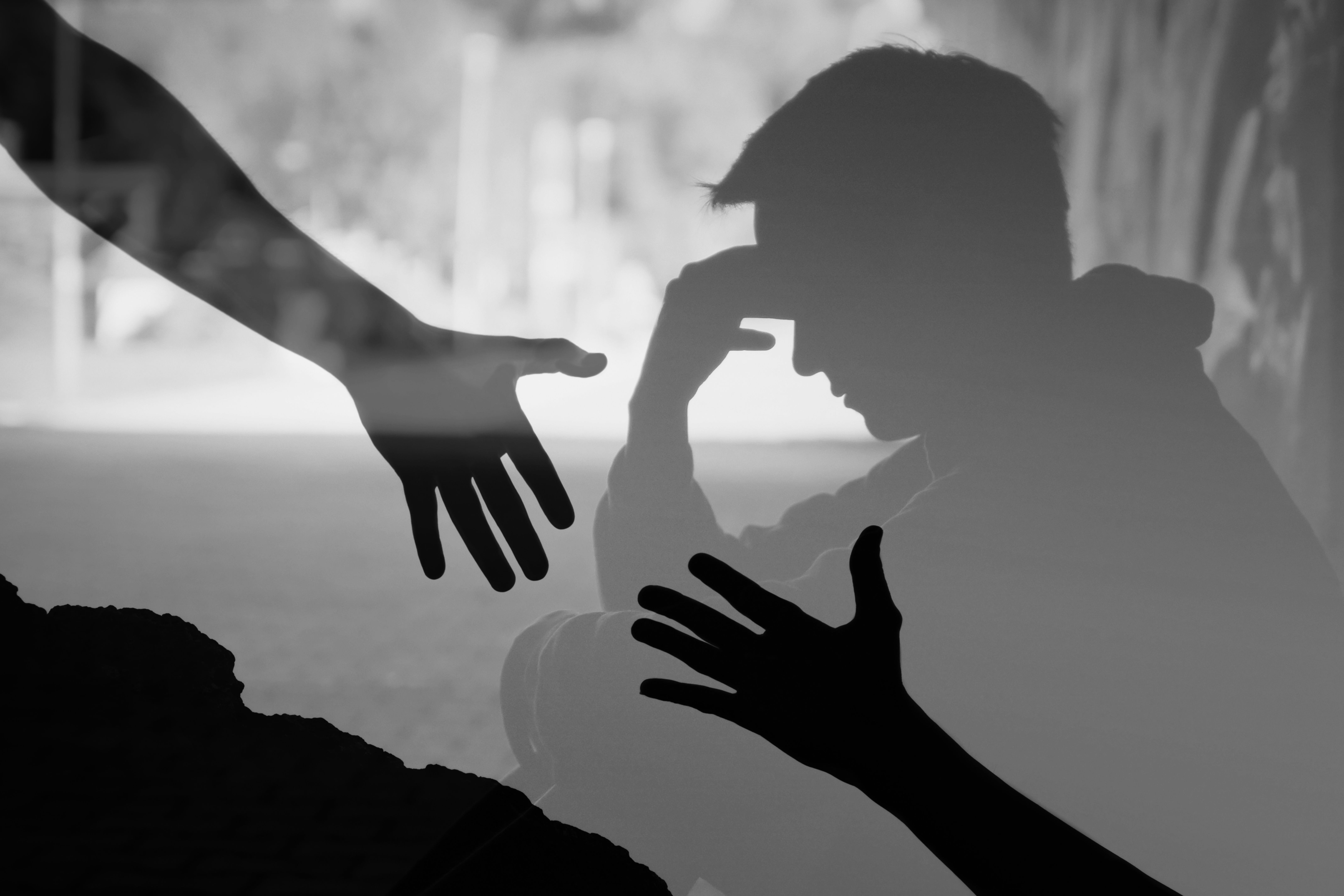 Man suffering from depression sadness needing a helping hand from a friend.