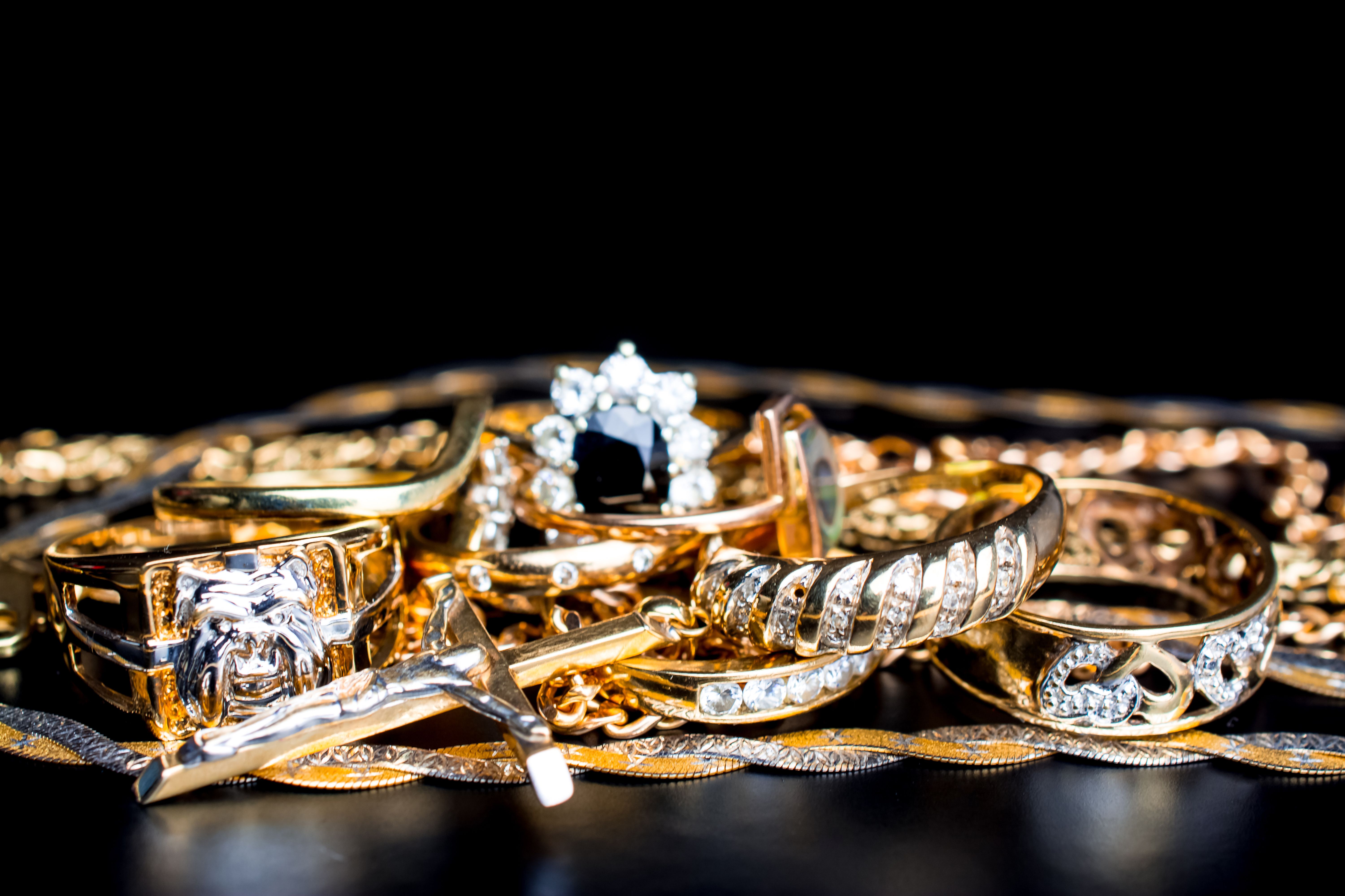 A golden scrap of old gold jewelry on black background