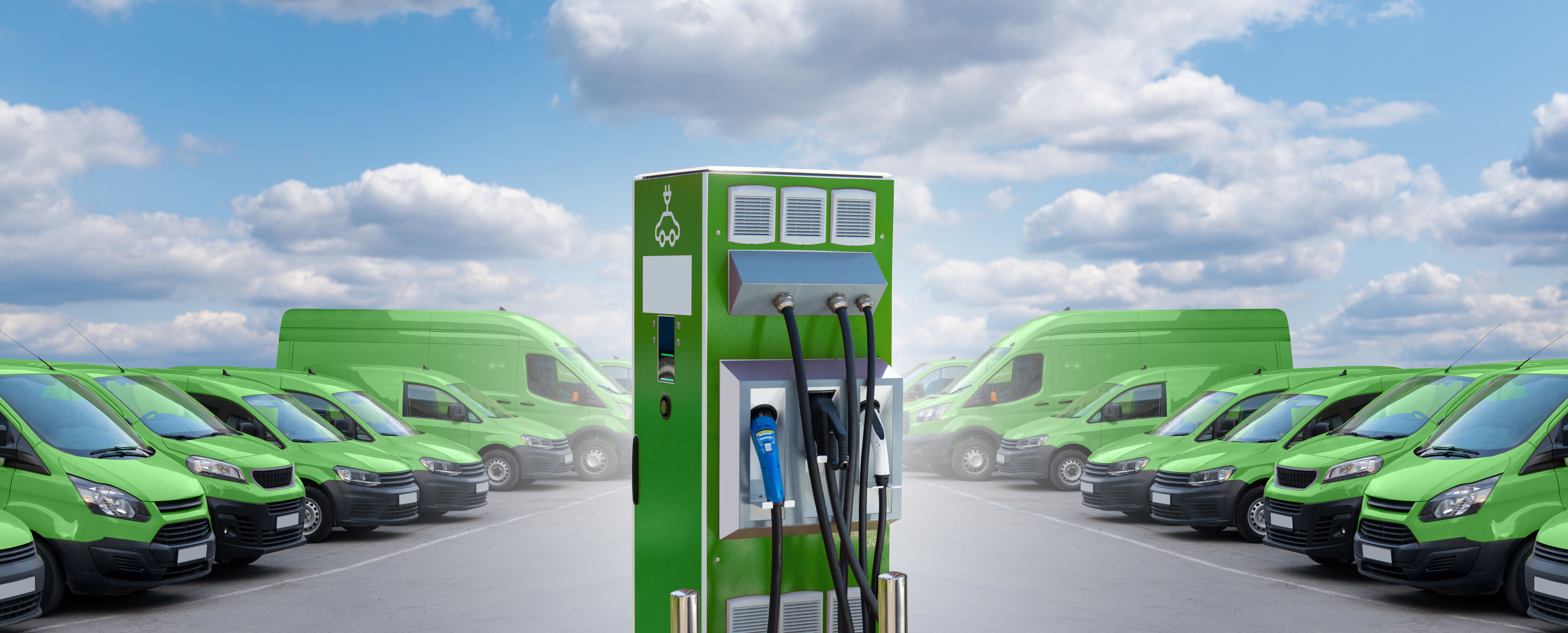 Electric vehicles charging station on a background of vans.