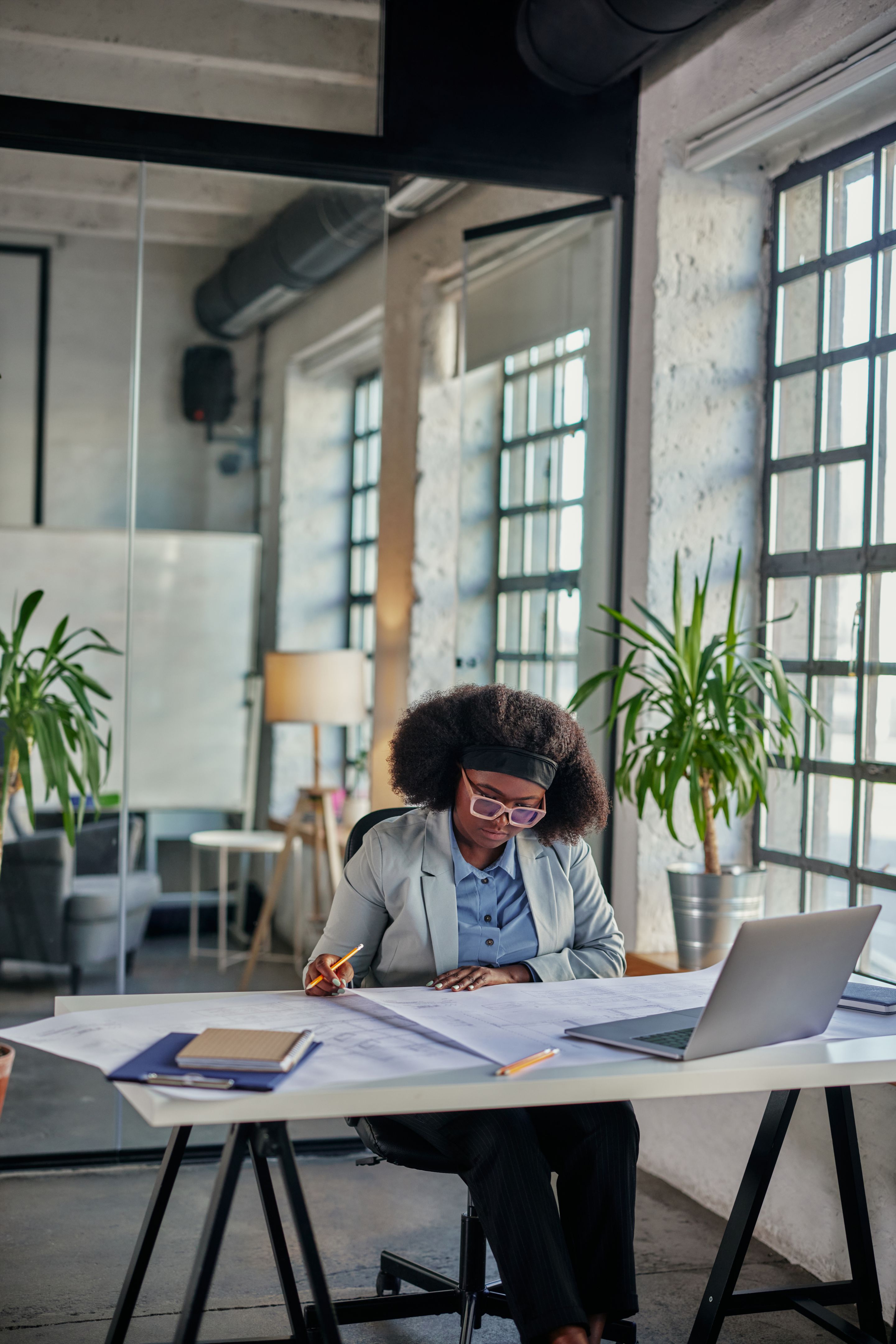 Businesswoman sitting at workplace in office and working