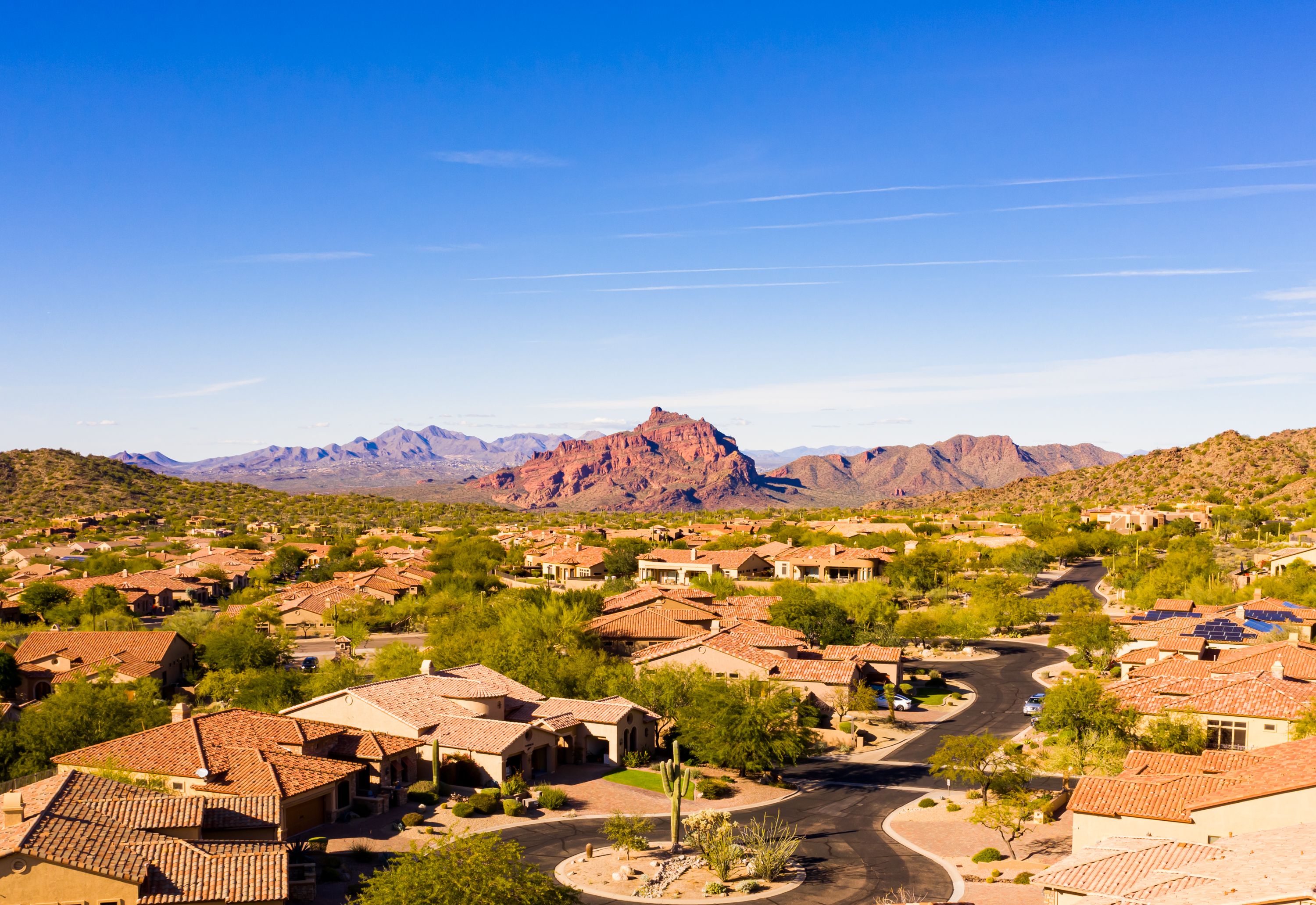 Aerial view over Scottsdale, Phoenix subdivision homes with blue skies and desert hill views all around Aerial view over Scottsdale, Phoenix subdivision homes with blue skies and desert hill views all around