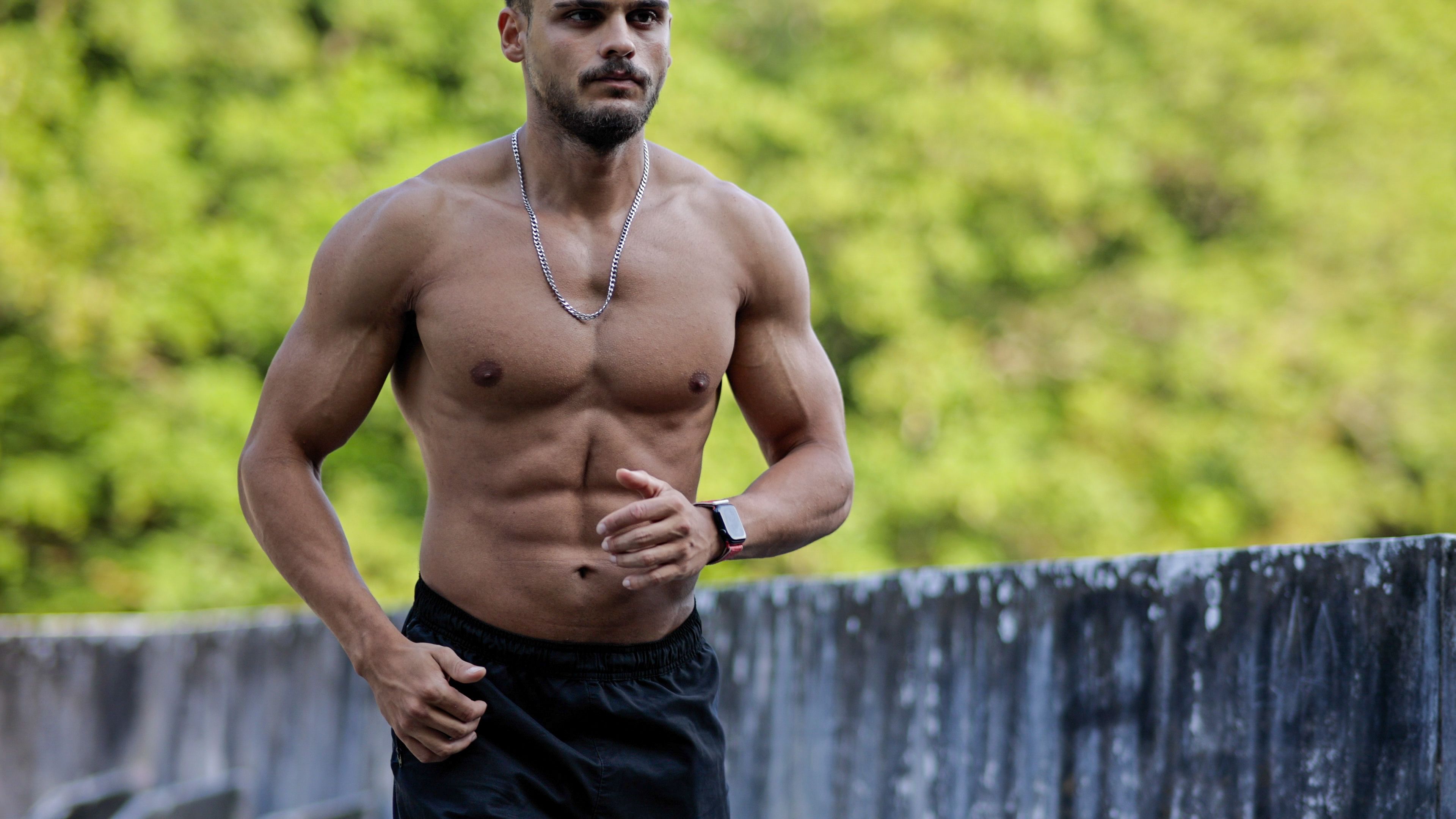 Muscular young man exercising outdoors, Young man doing running exercise, Man with beautiful body jogging naked, Muscular man with bare torso running outdoors, Morning exercises