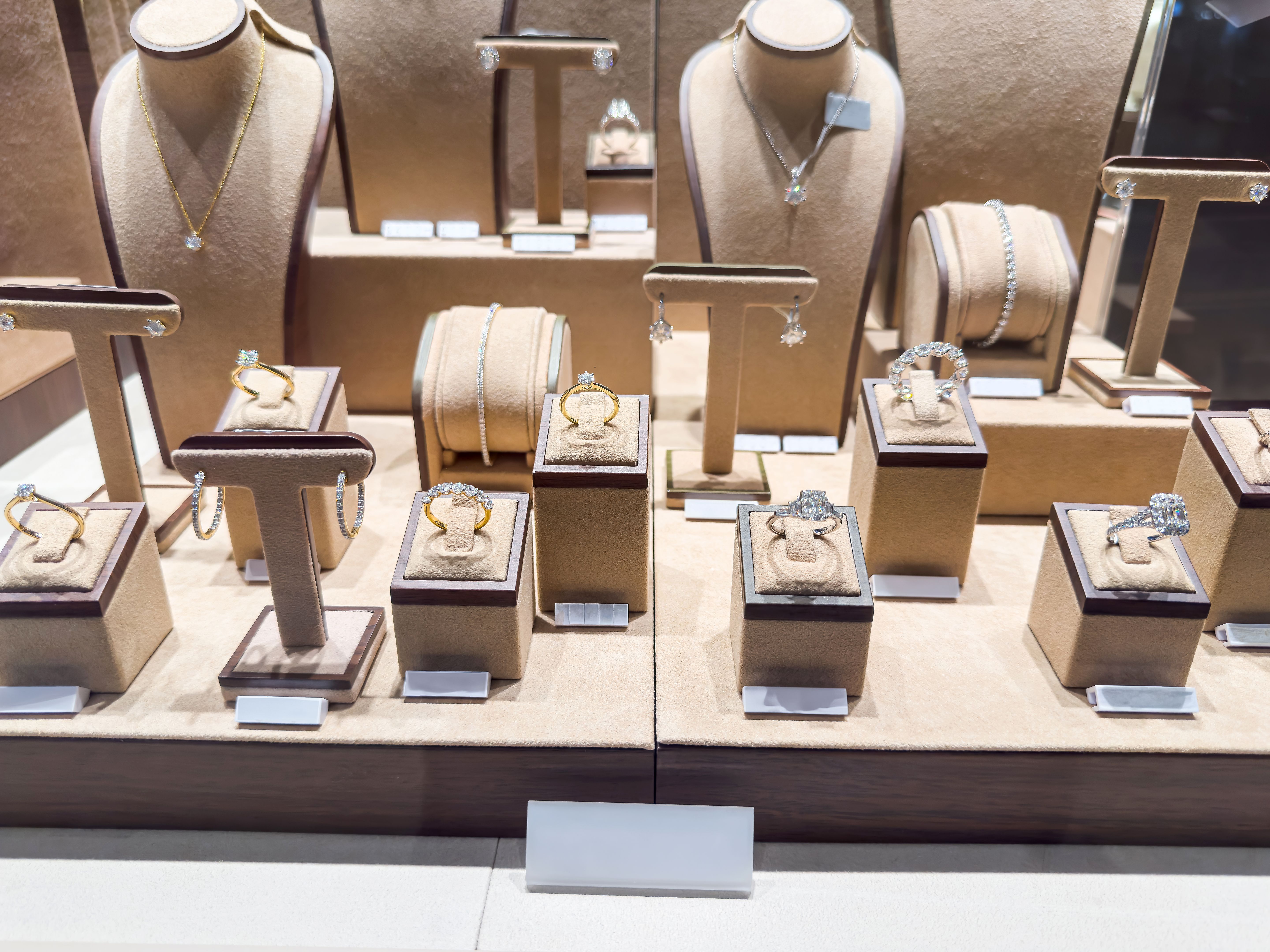 Showcase with luxury golden diamond necklaces, bracelets and earrings in a jewellery shop