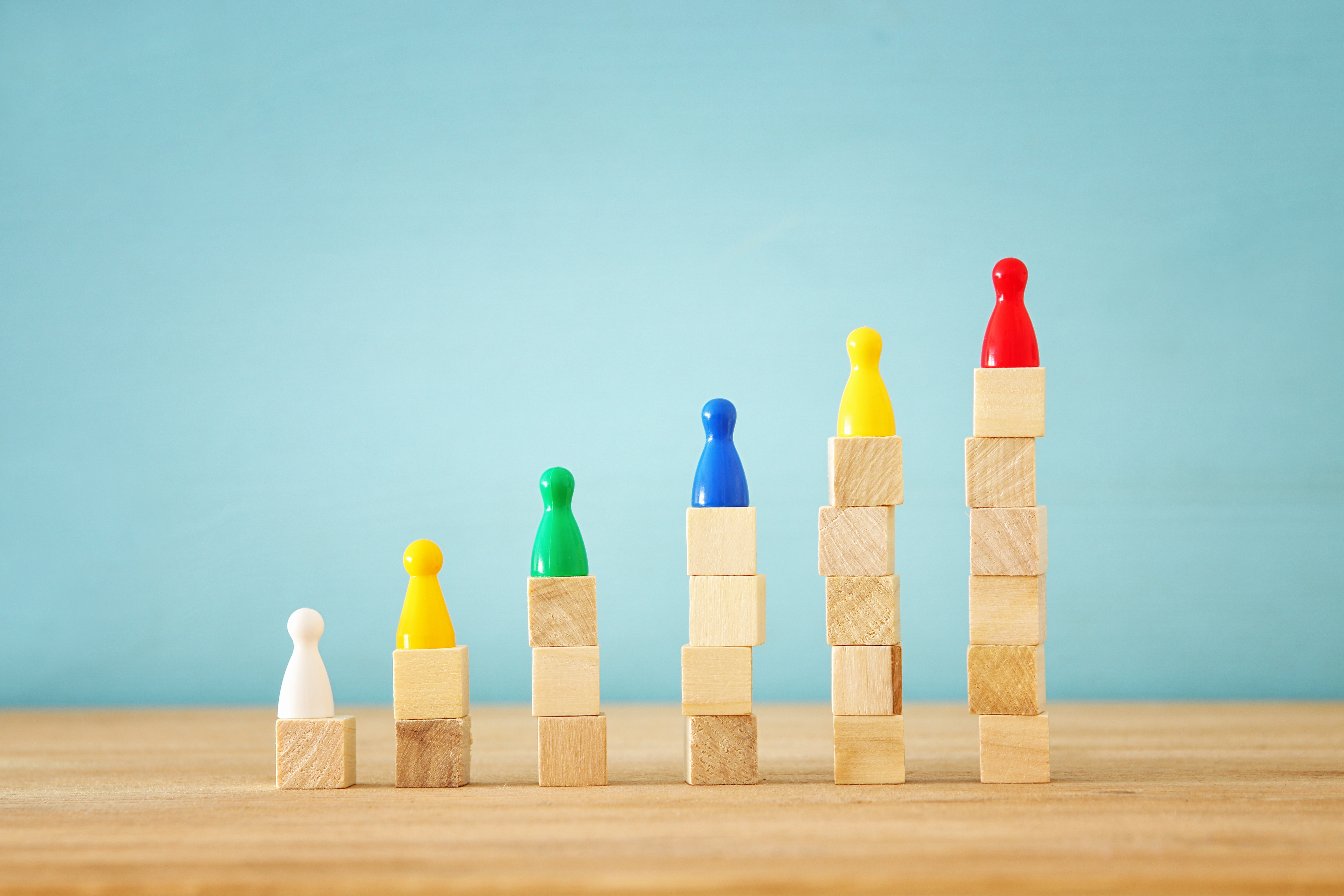 concept image of hand putting figure on top of chart, human resources and management concept.