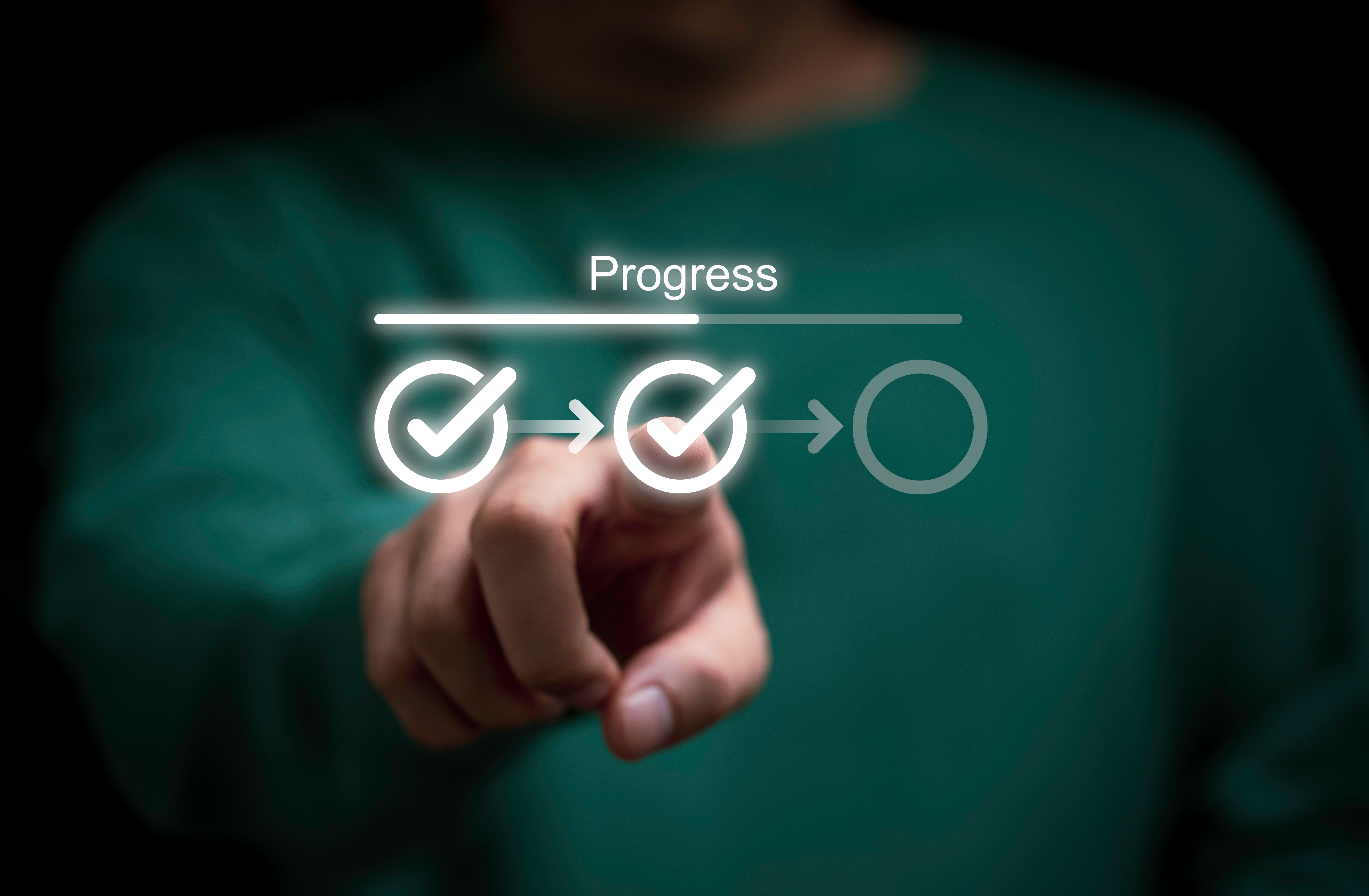 Businessman touching to tick correct mark in checklist with progressive loading status to remind work task progressive for project develop management and tracking concept.