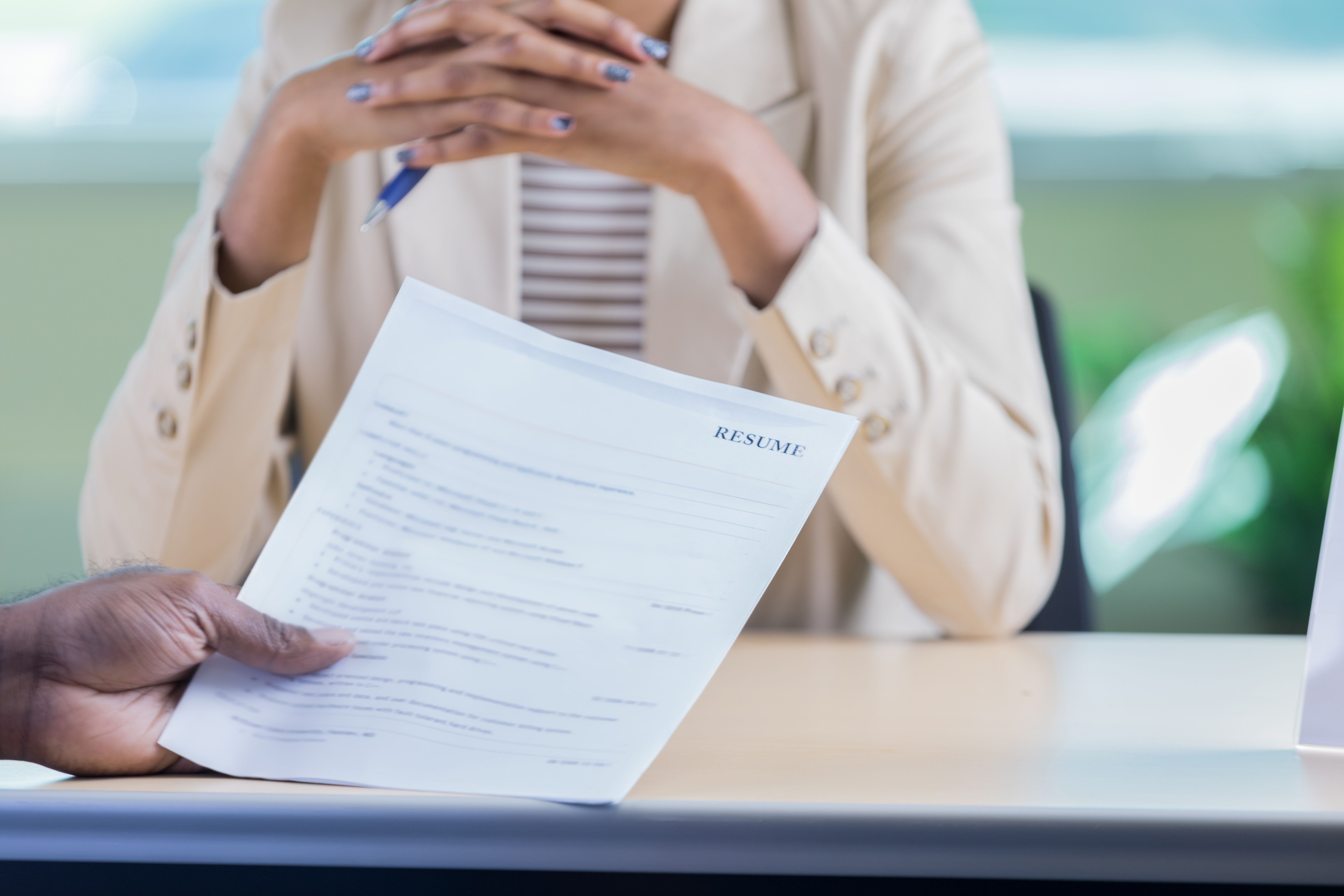 Unrecognizable businessman holds a job candidate's resume