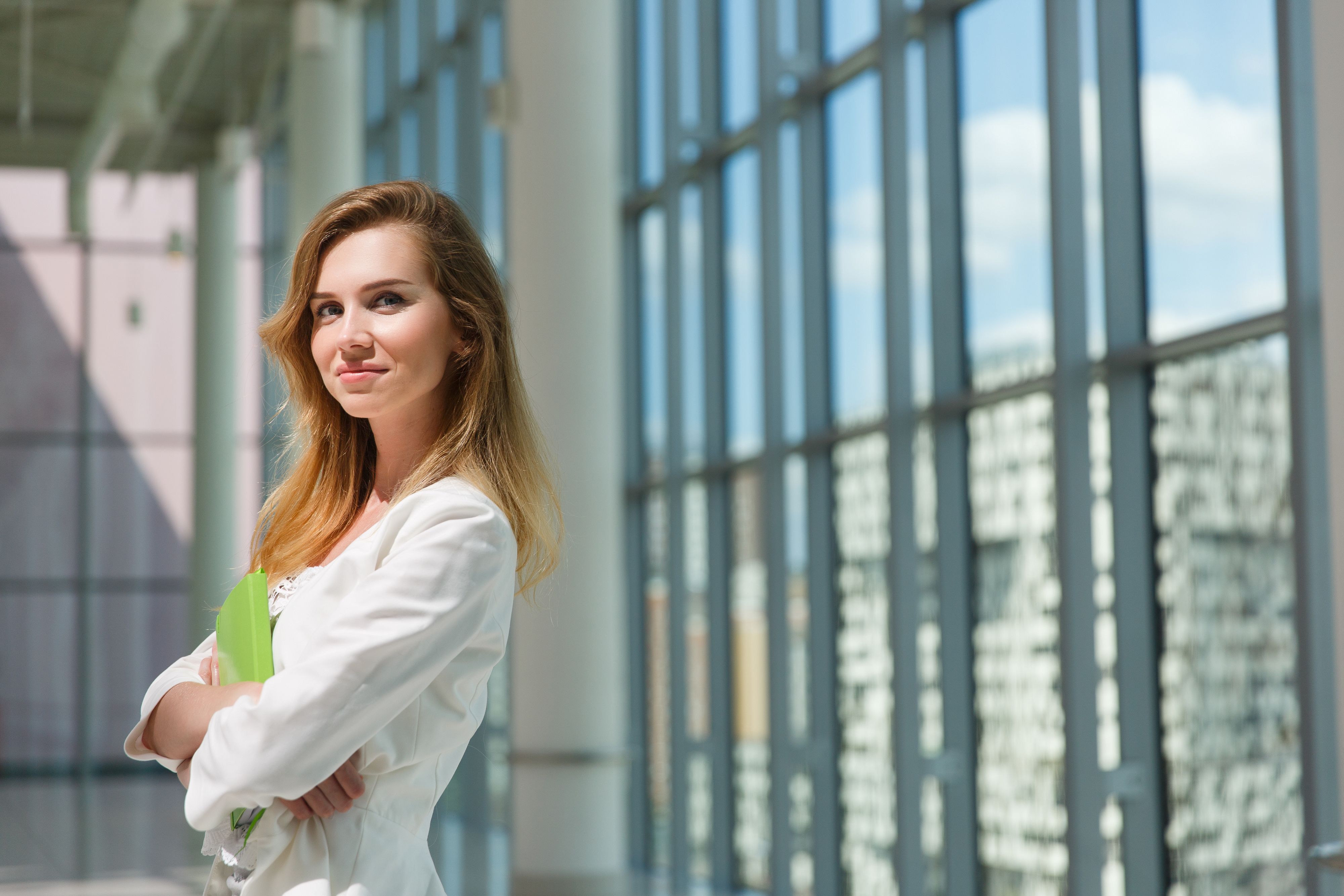 Young beautiful woman holding green notebook. Young beautiful woman holding green notebook.
