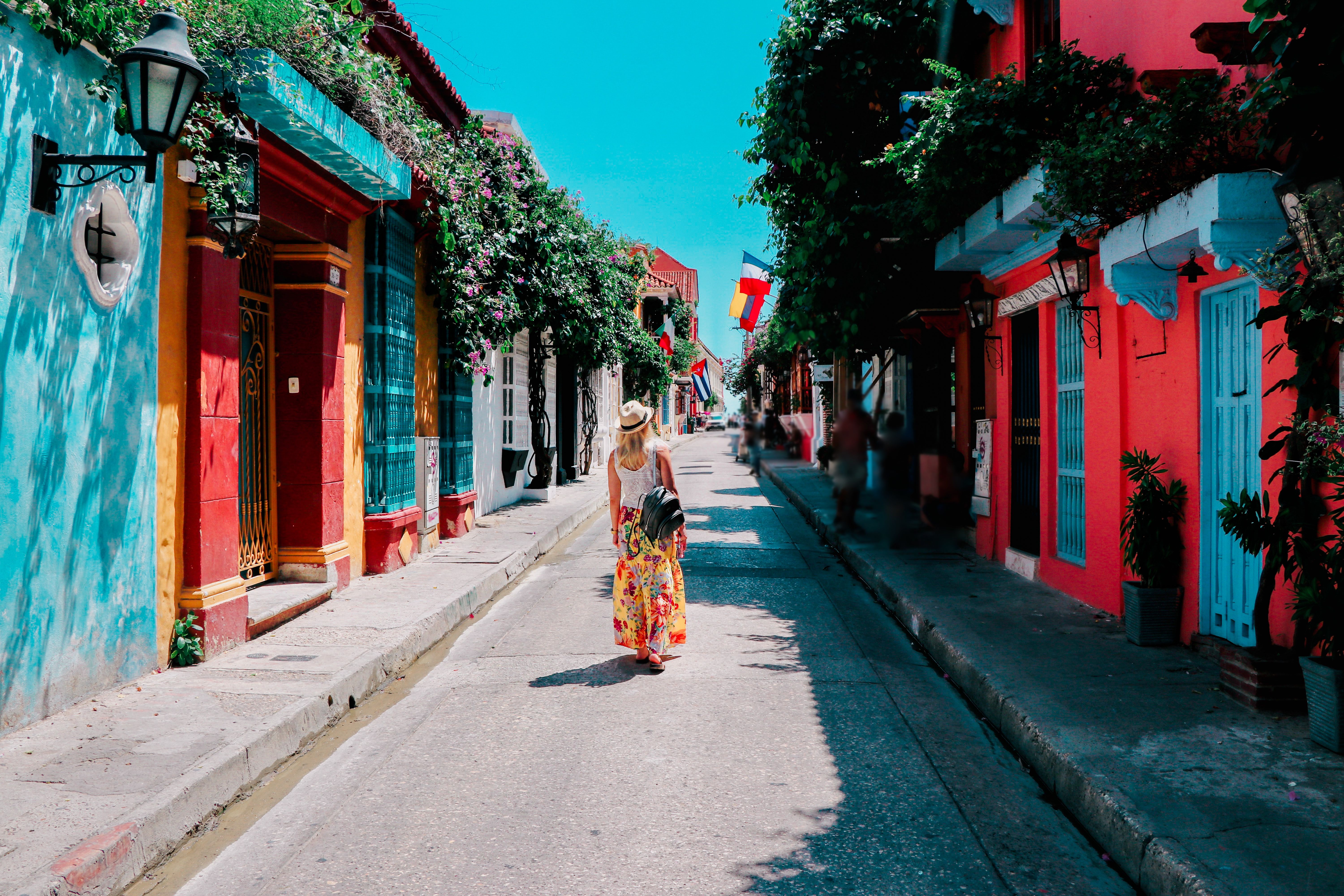 Young woman walking on a street of historical city of Cartagena, Colombia
