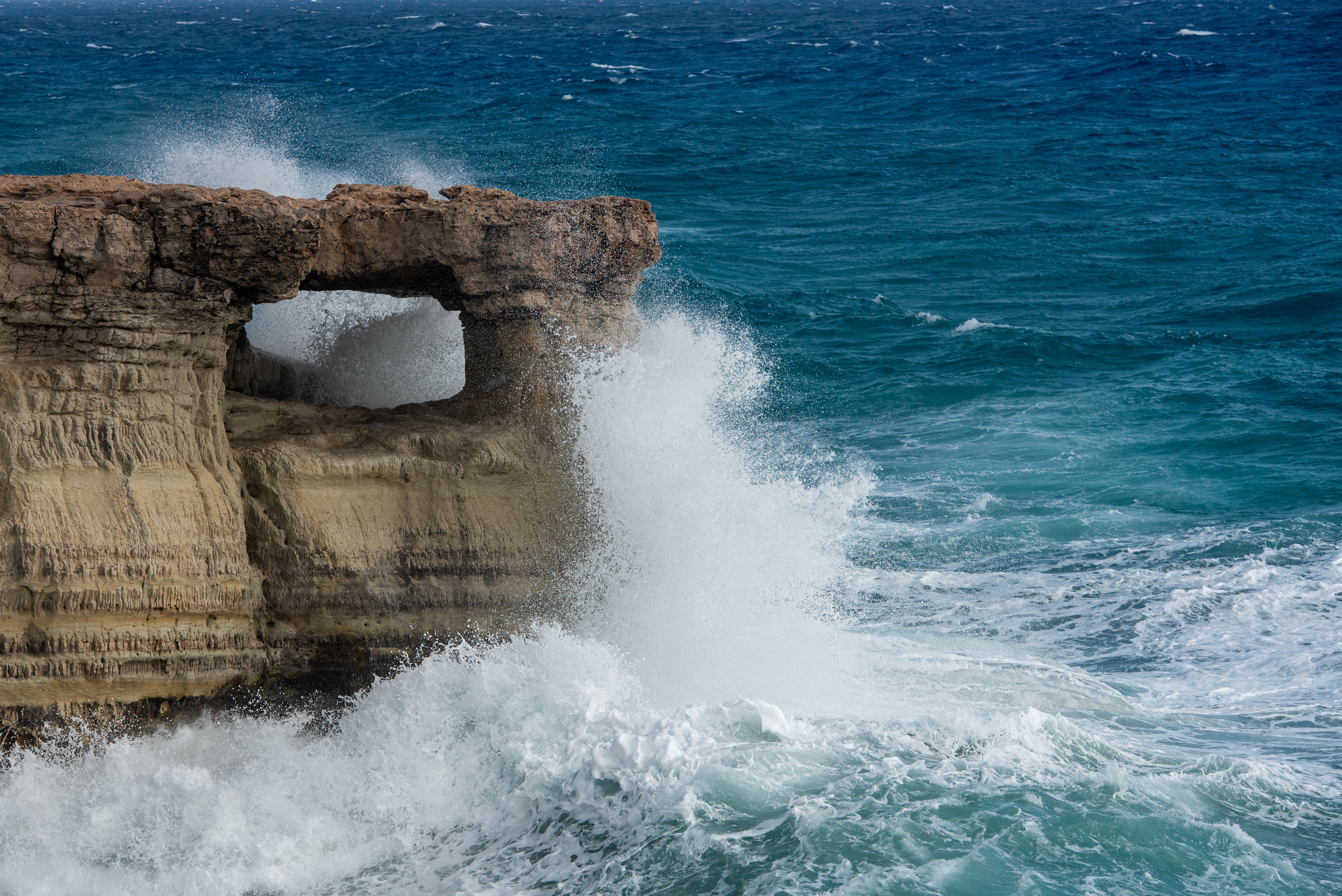 waves crashing on rocky coast. Windy weather , Powerful sea waves braking on rocks.