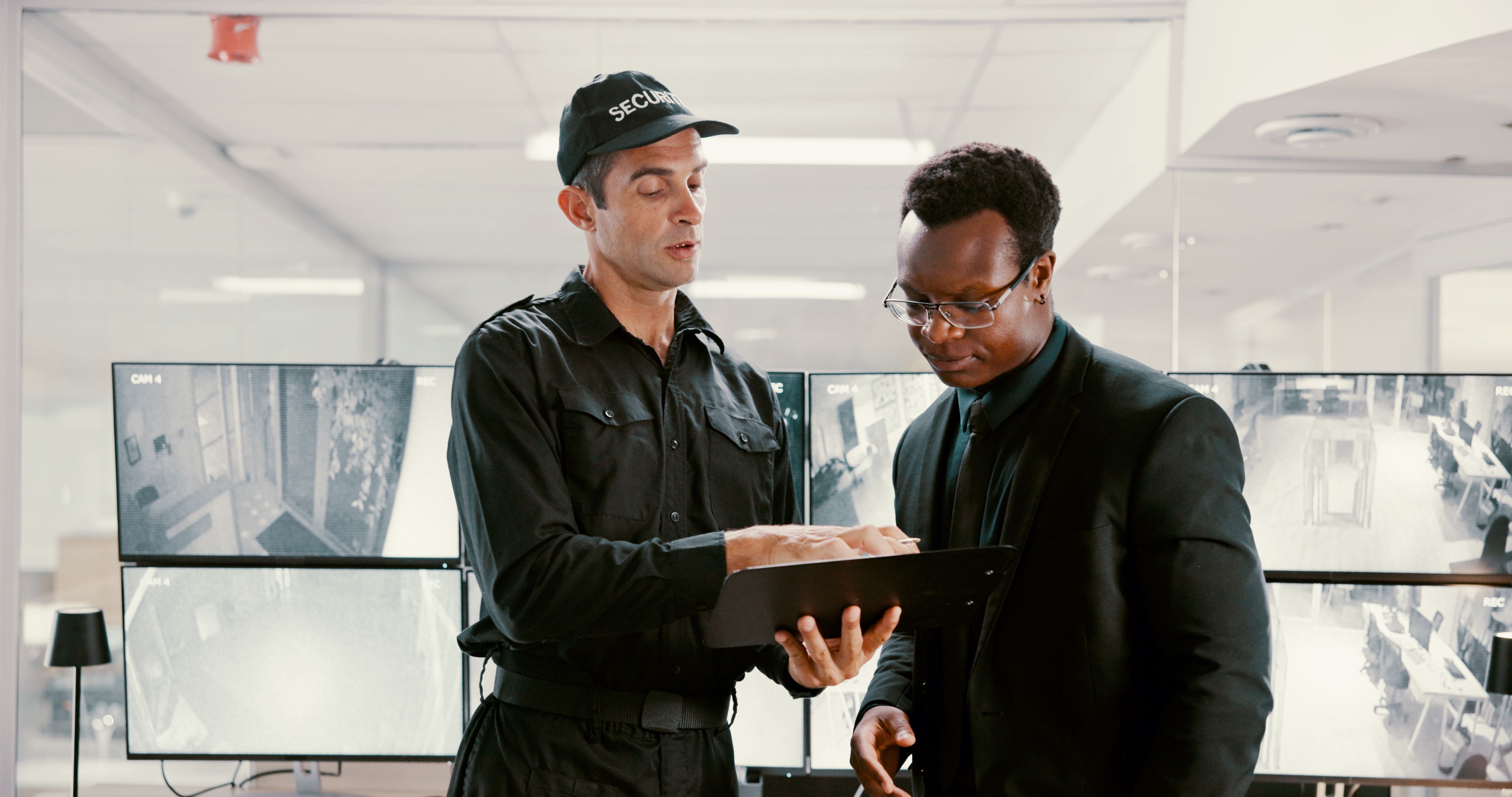 Watching, surveillance and team with tablet, security and review of footage for safety or collaboration. Control room, talking and people with computer for observation, video and protection with tech