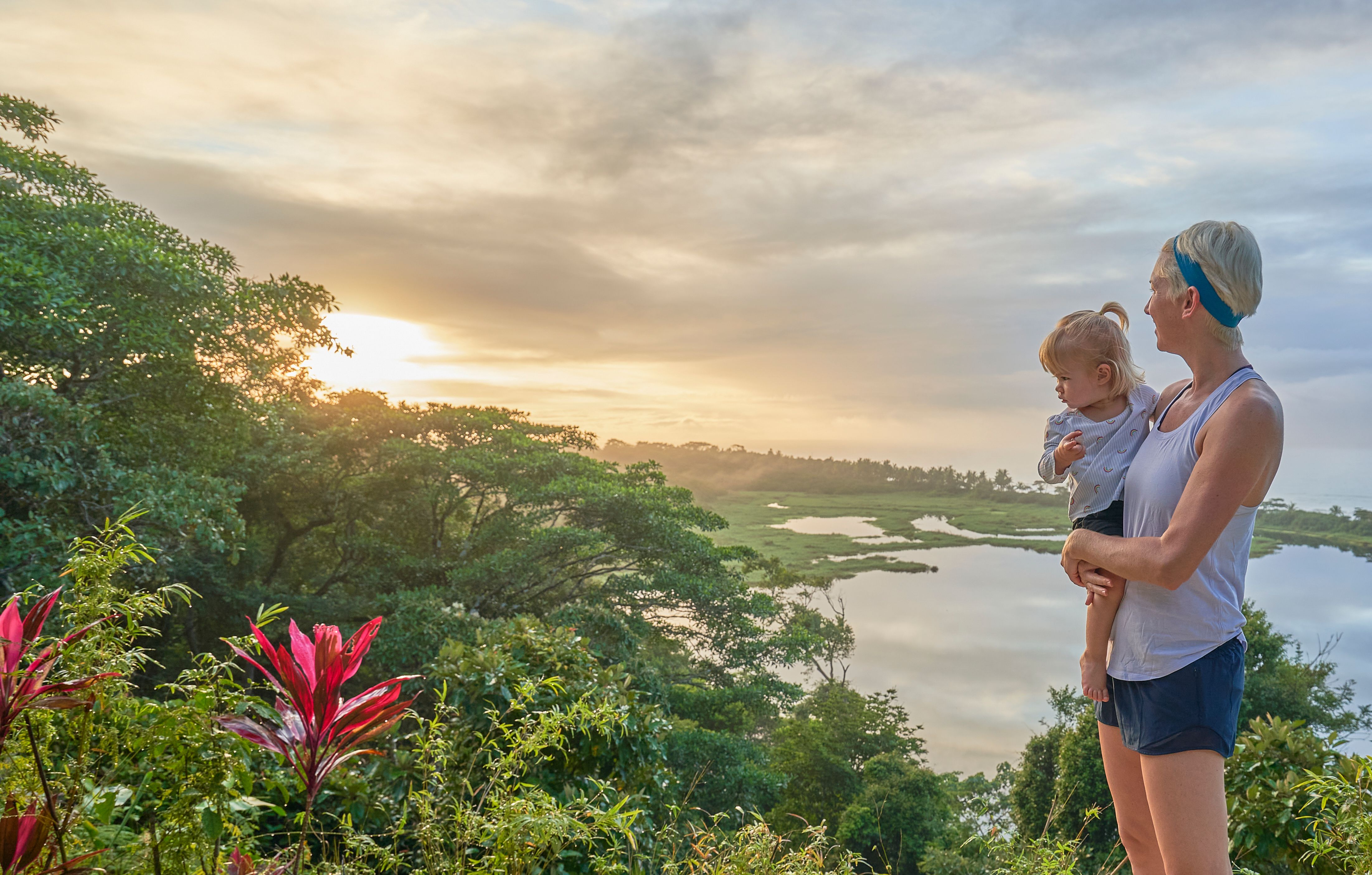 Mother & Daughter Watching the Sunrise Over a Lagoon and the Pacific in Corcovado National Park on the Osa Peninsula in Costa Rica