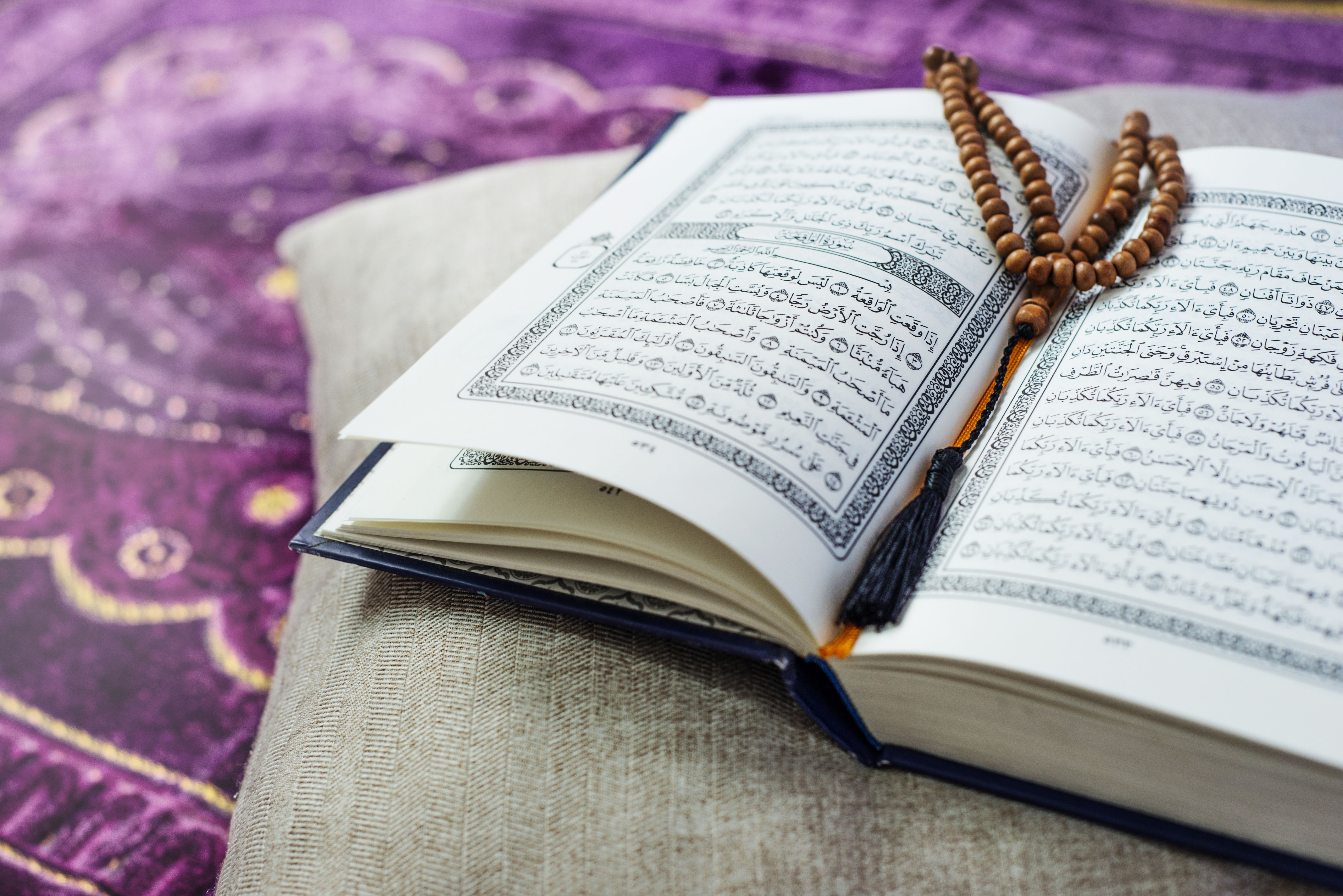 Al-Quran and beads with natural light at home