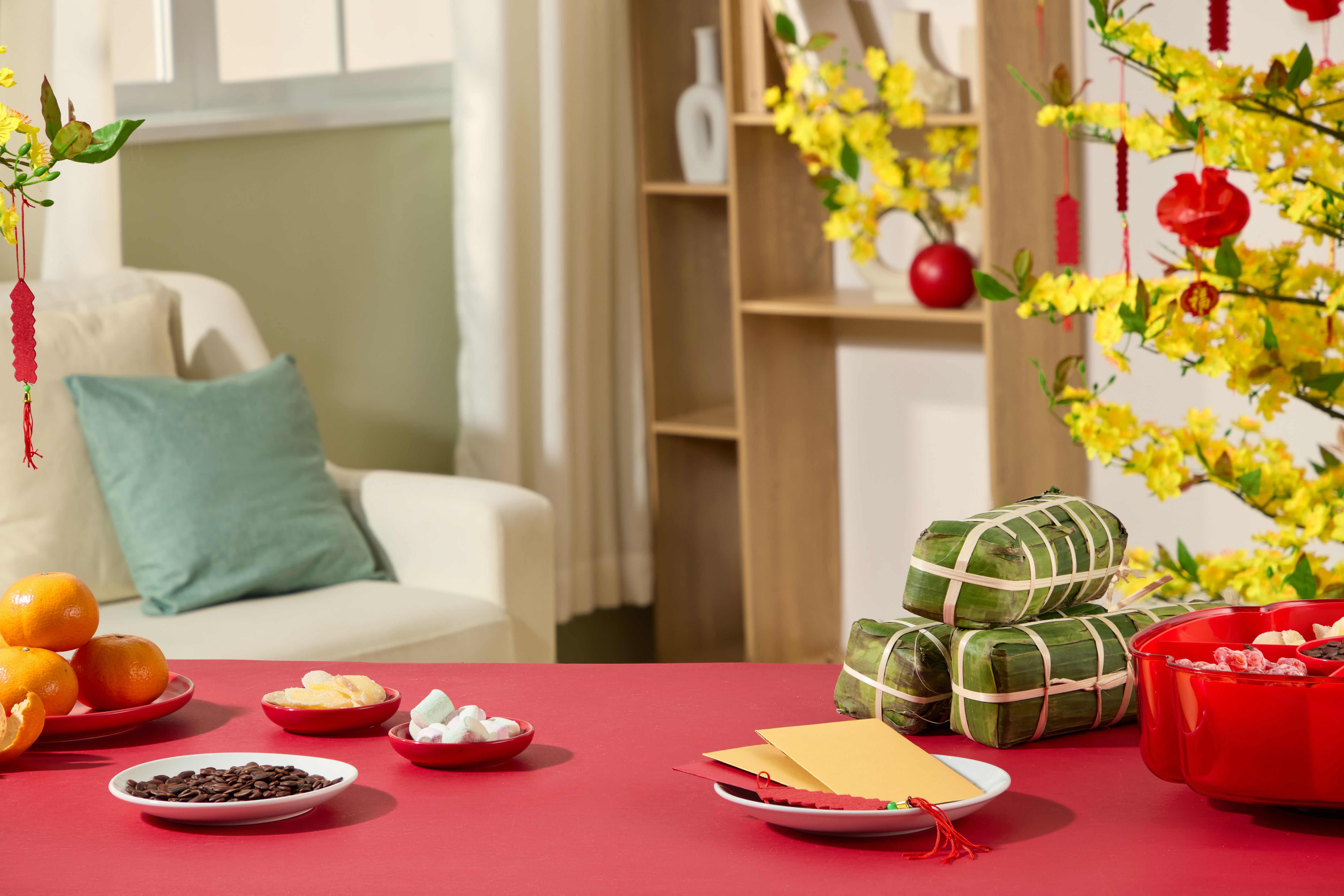 Tet celebration in Vietnam with yellow blossoms and sticky rice cake.