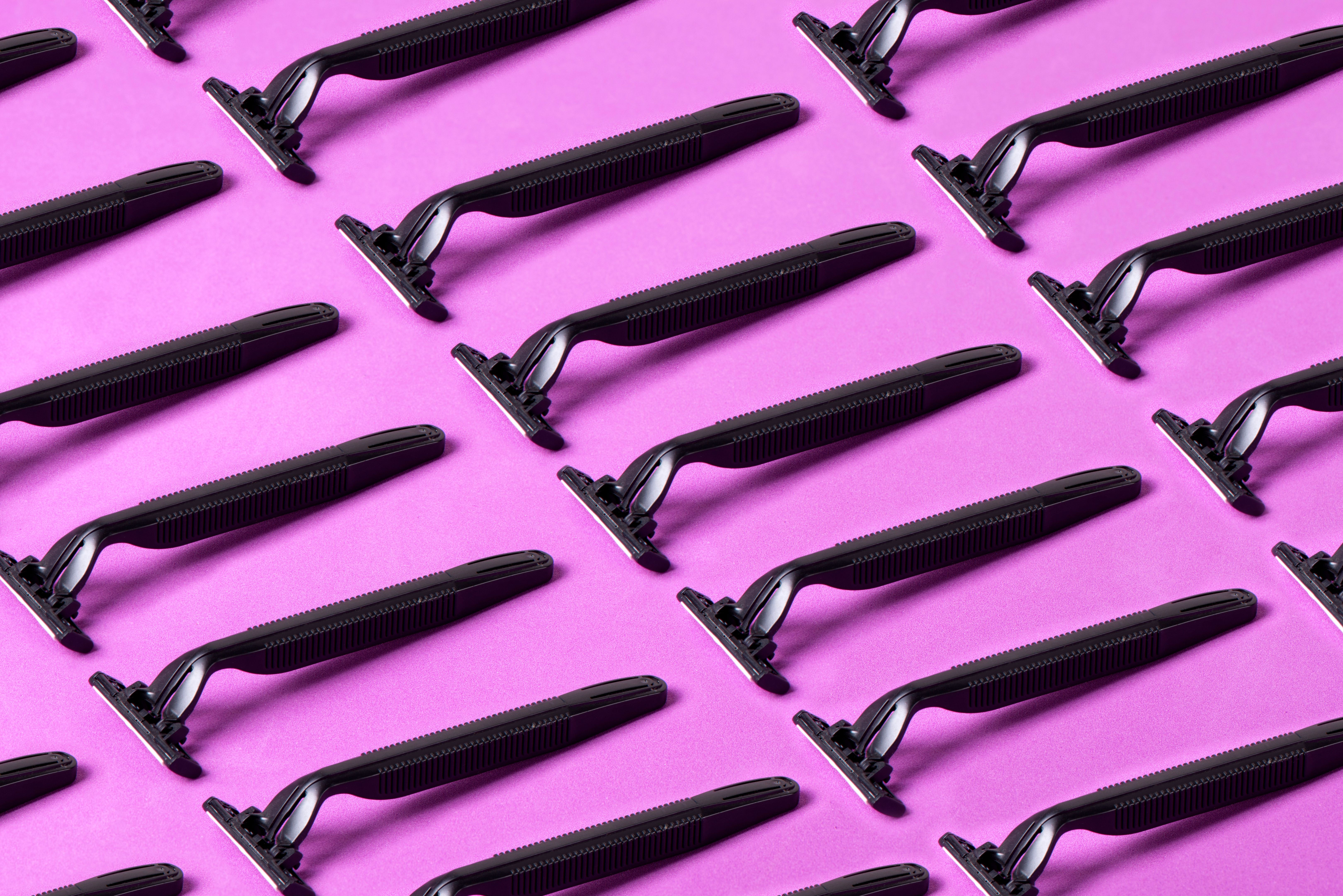 Razor Blades On Purple Background