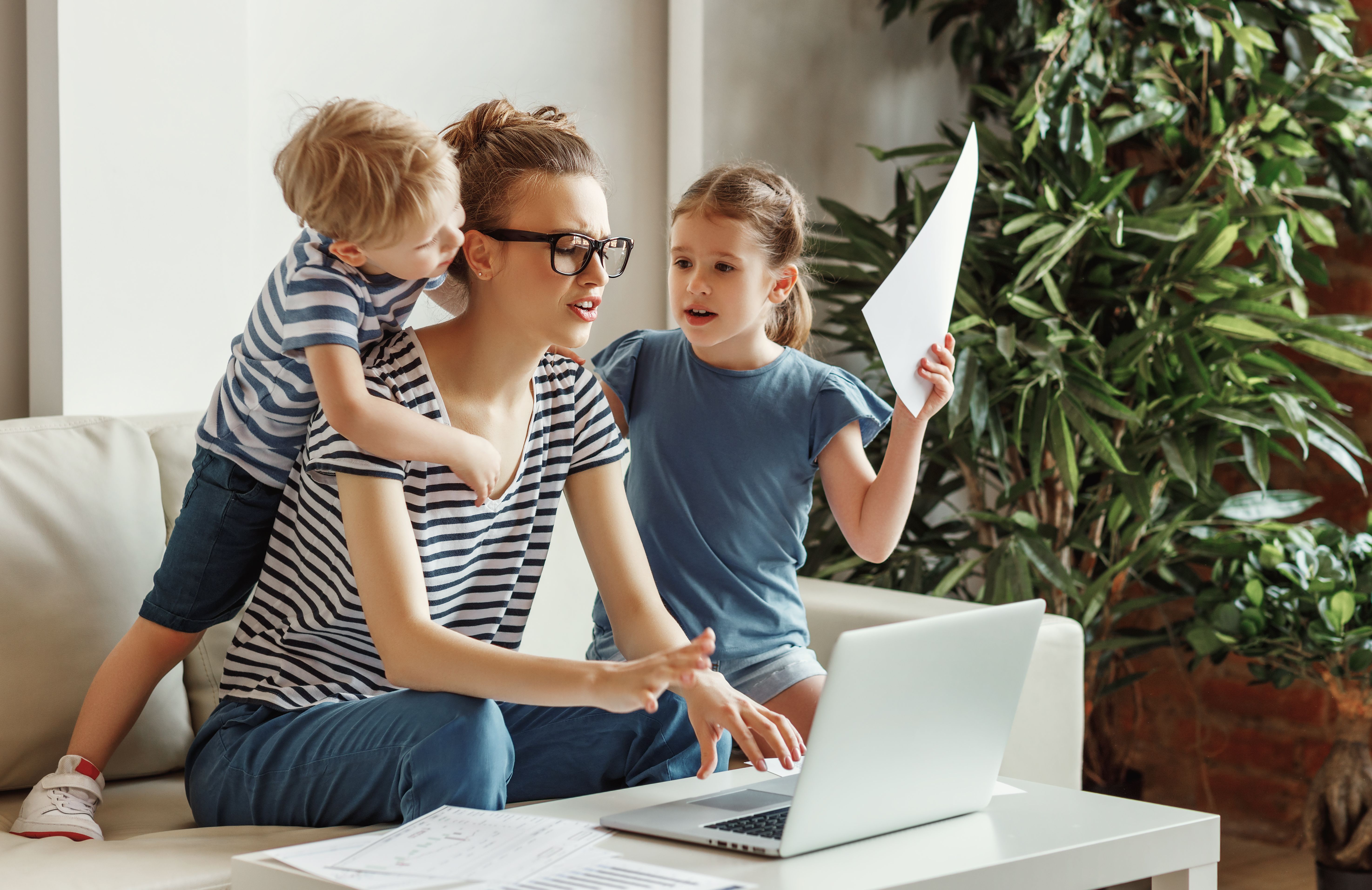 Stressed woman with kids working from home