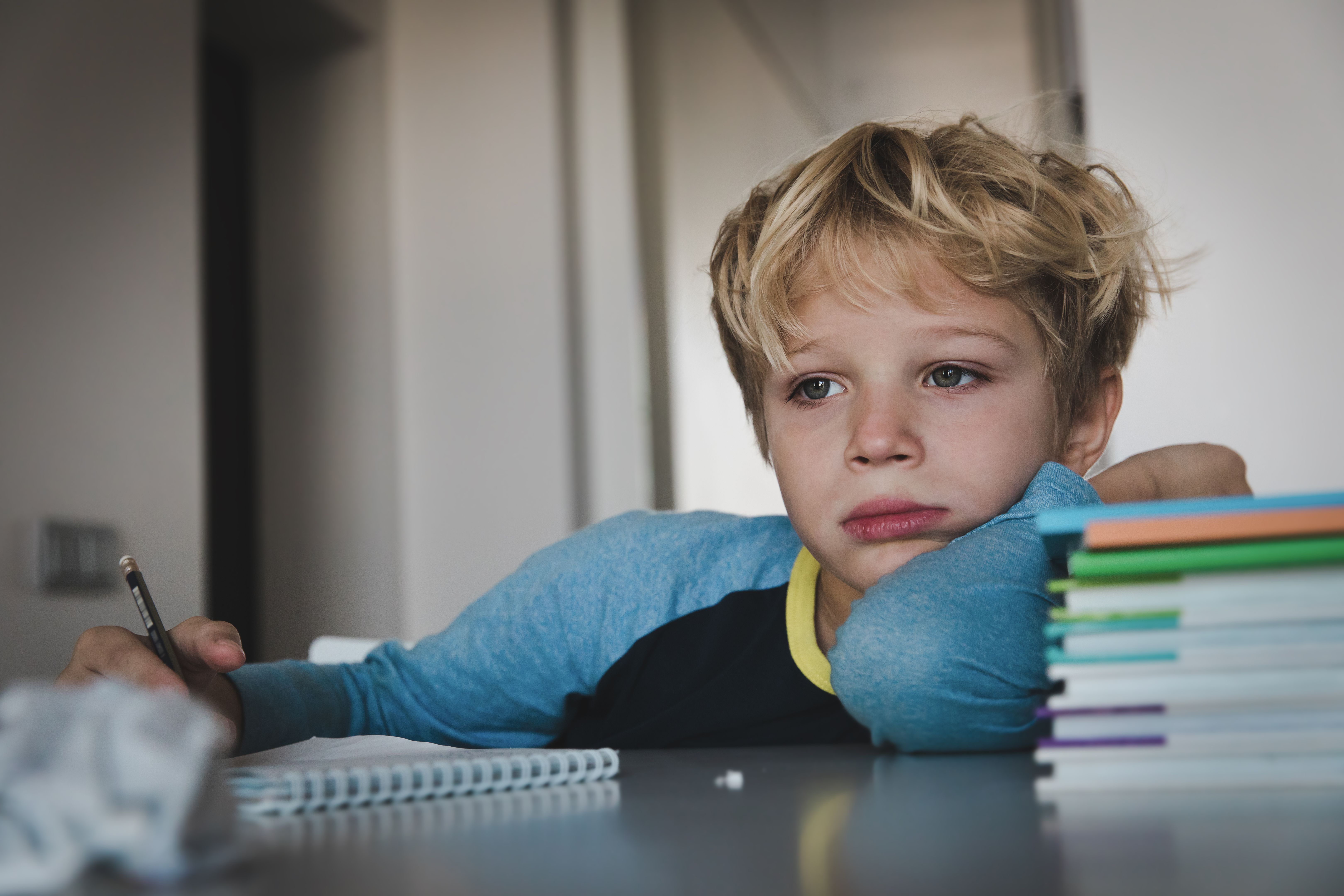 little boy tired stressed of reading, doing homework