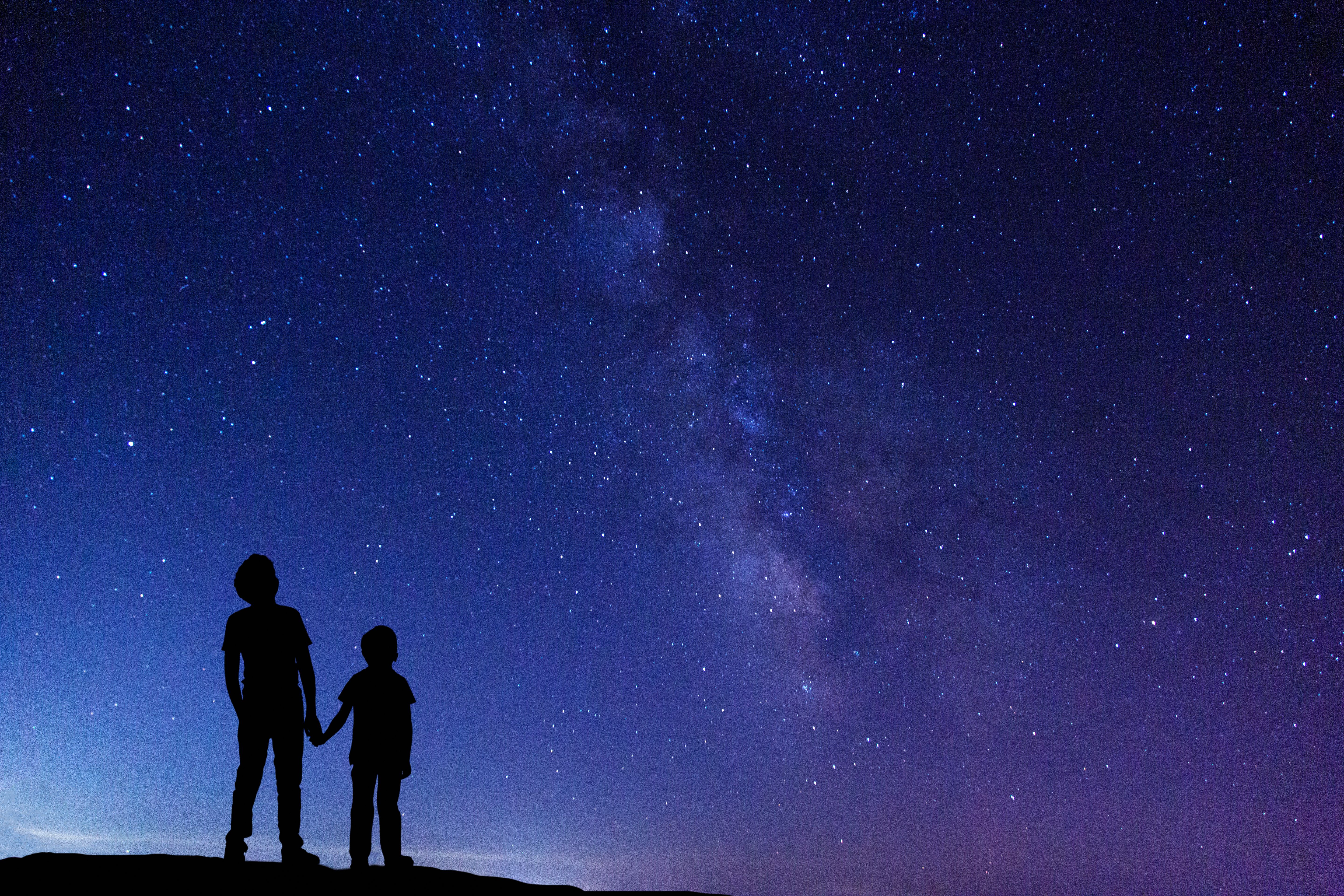 Two boys looking at Milky Way