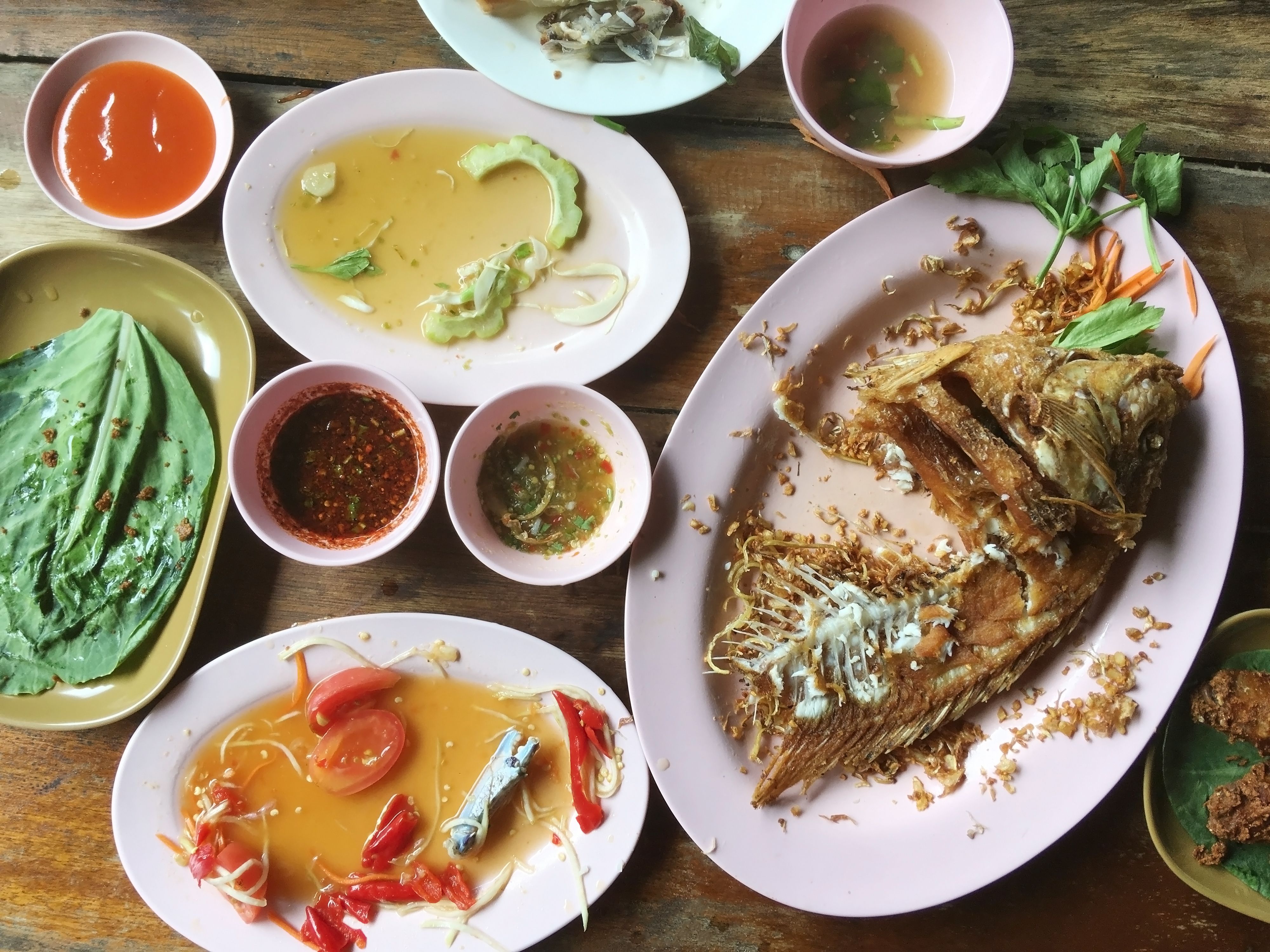 Dirty plates after eating with scrap food on wood table