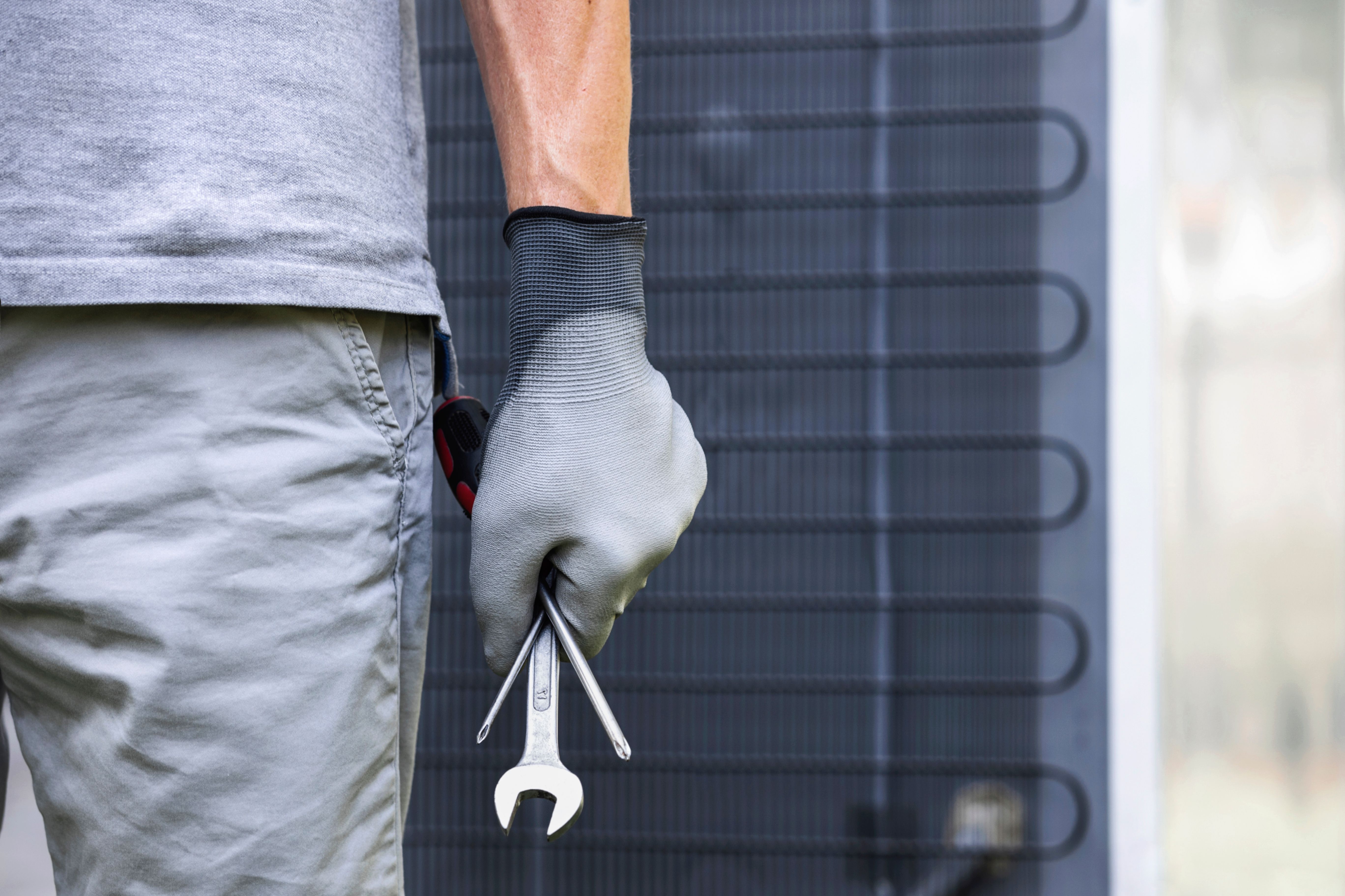 technician repairing air conditioner