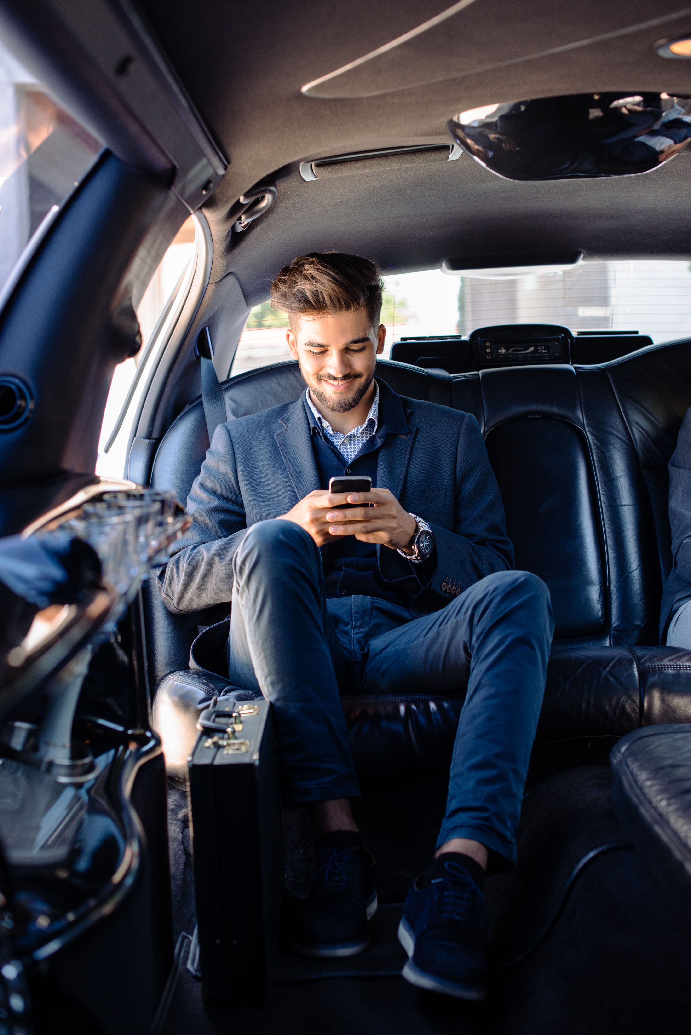 Businessman texting in limo Businessman texting in limo