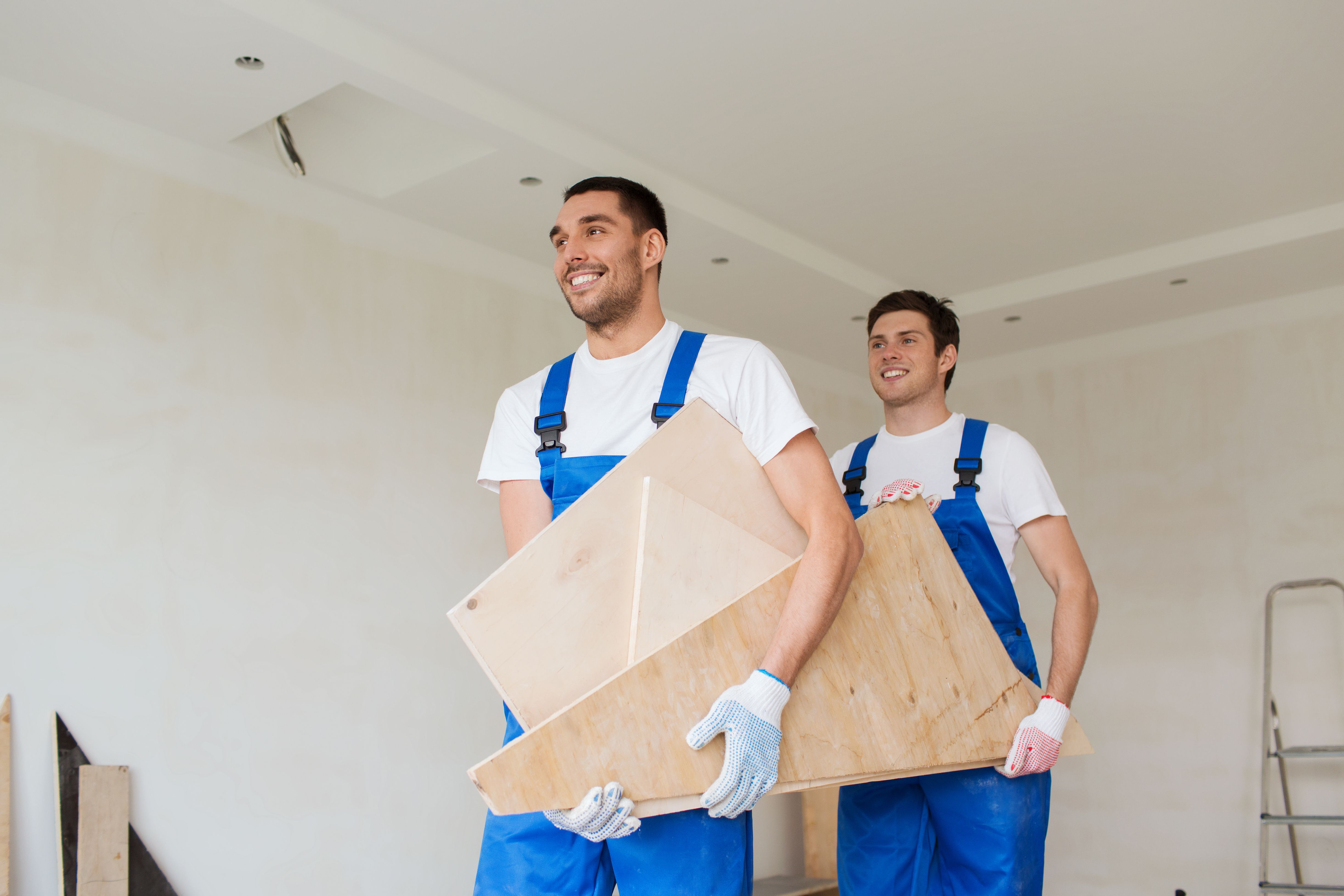 group of builders with wooden boards