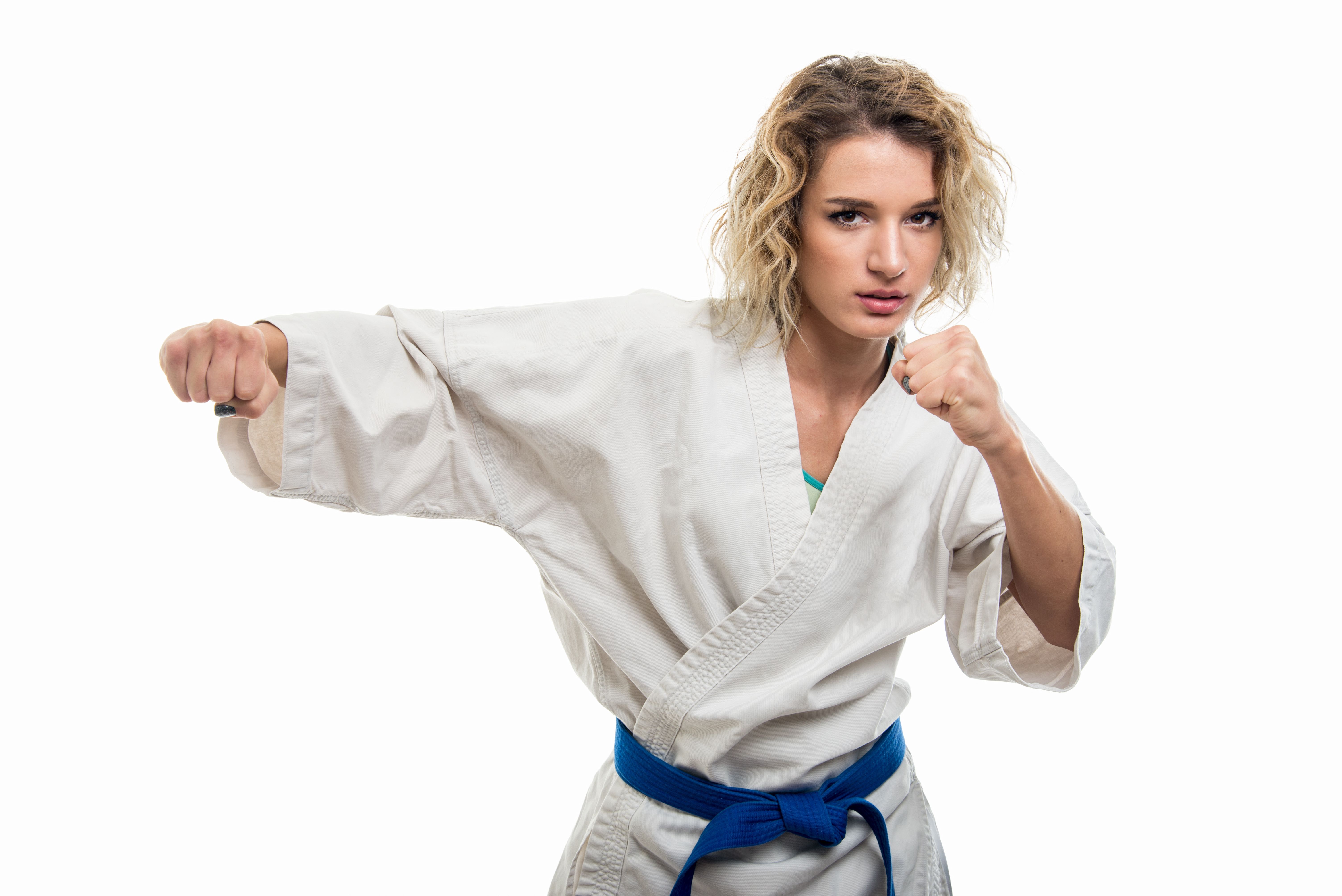 Portrait of female wearing martial arts uniform holding fists
