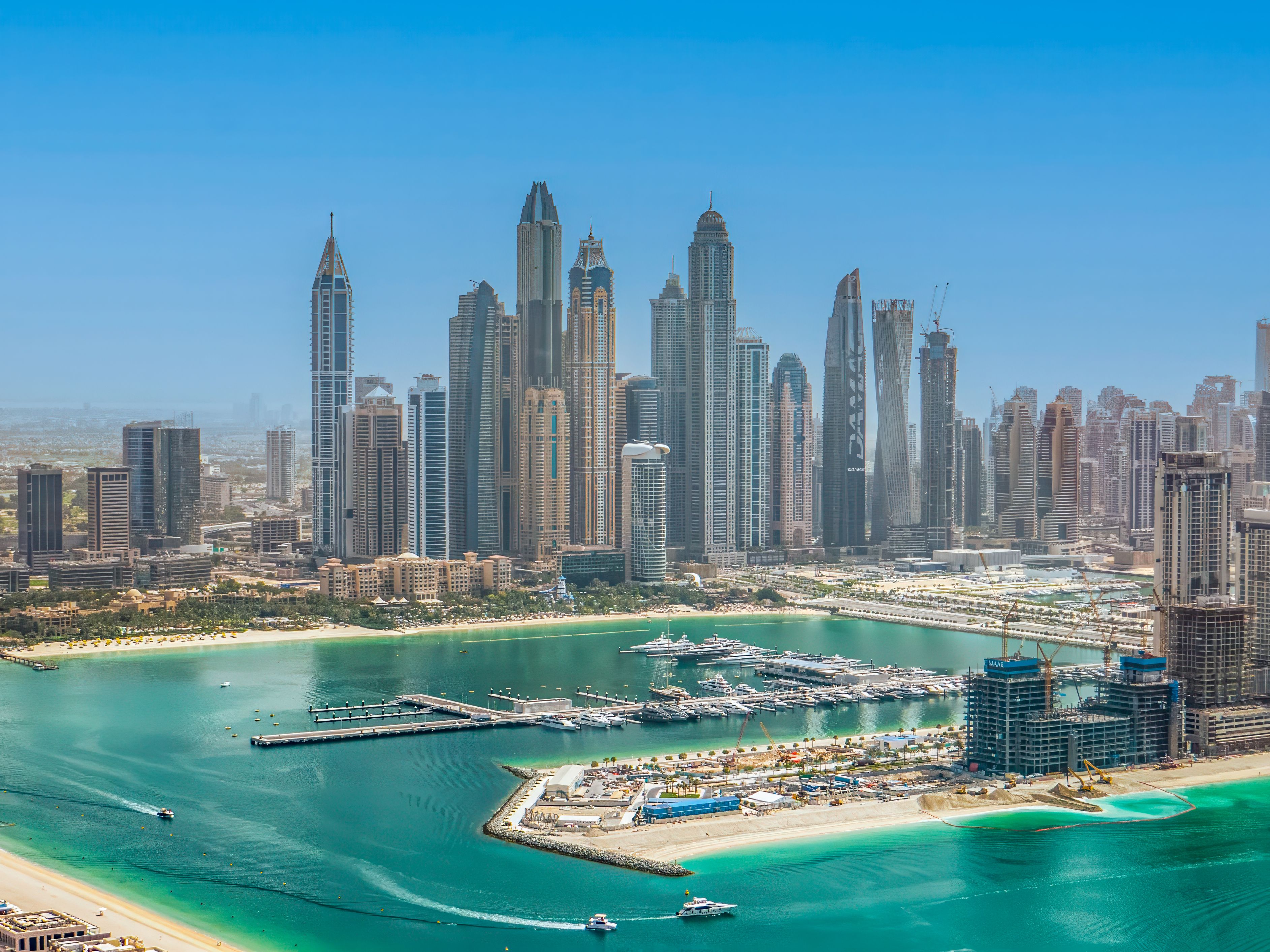 Dubai, UAE. Dubai Marina skyscrapers view at golden sunset with beautiful reflection in water.