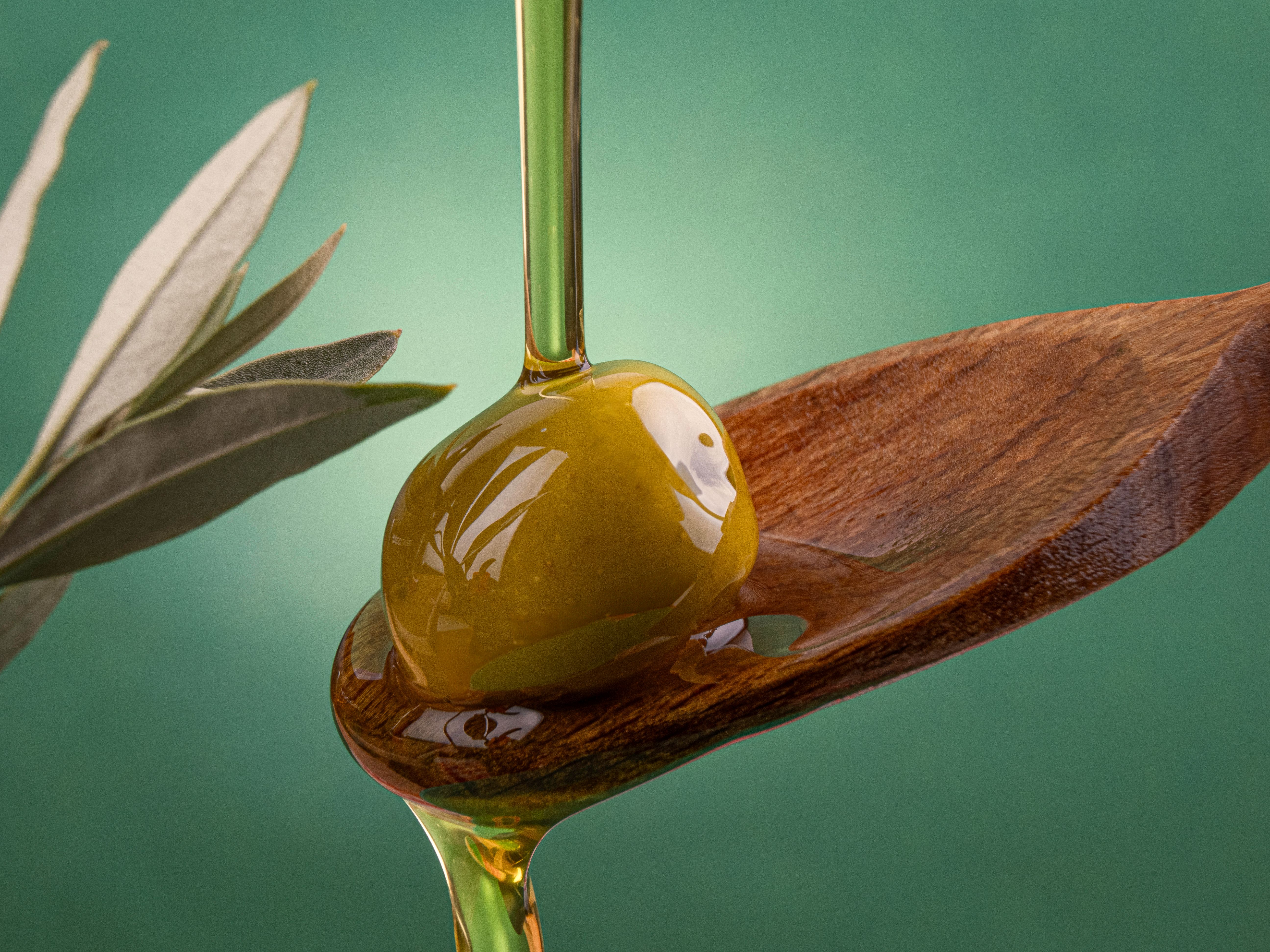 Olive oil poured into the spoon