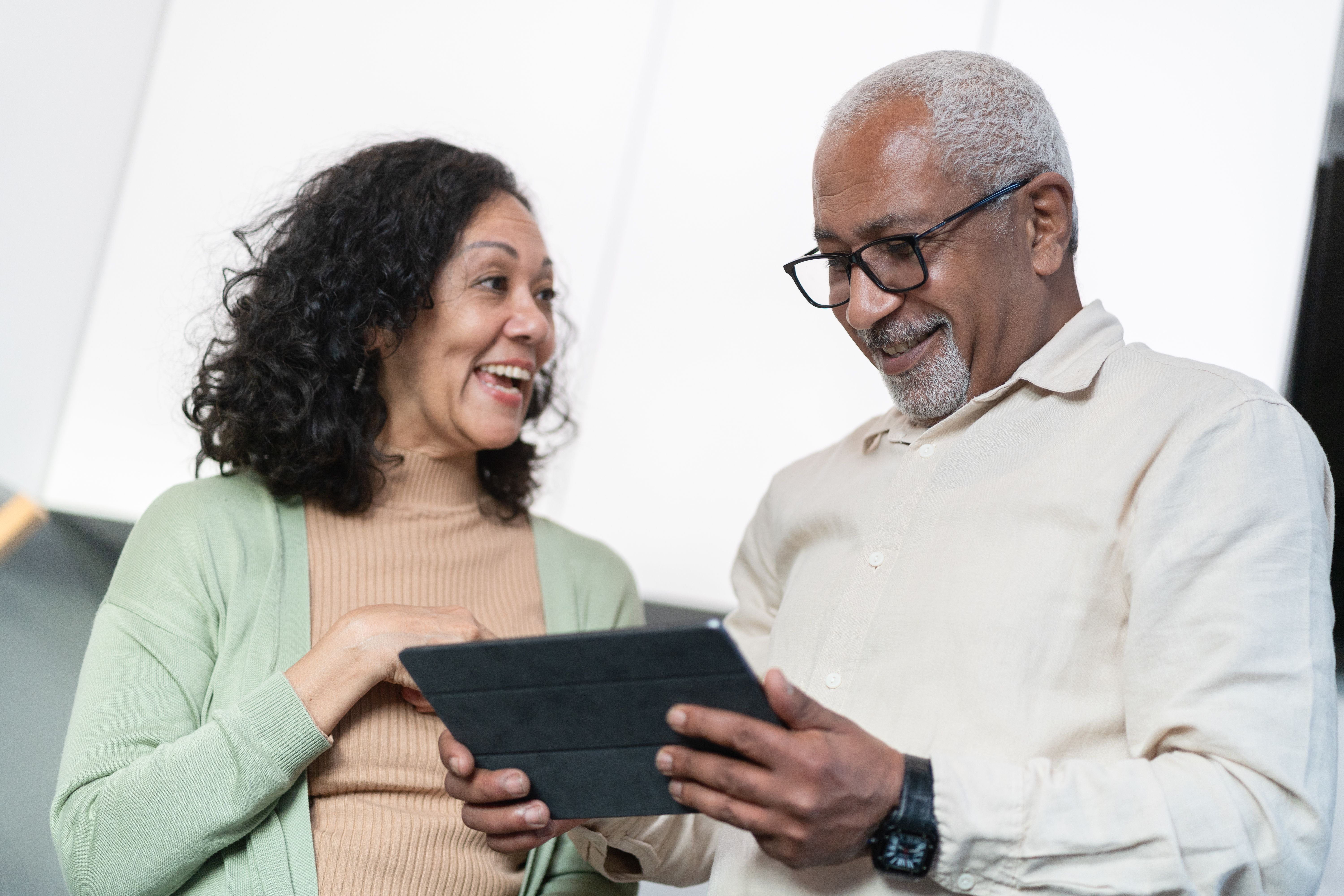 Senior couple using and looking ata tablet computer