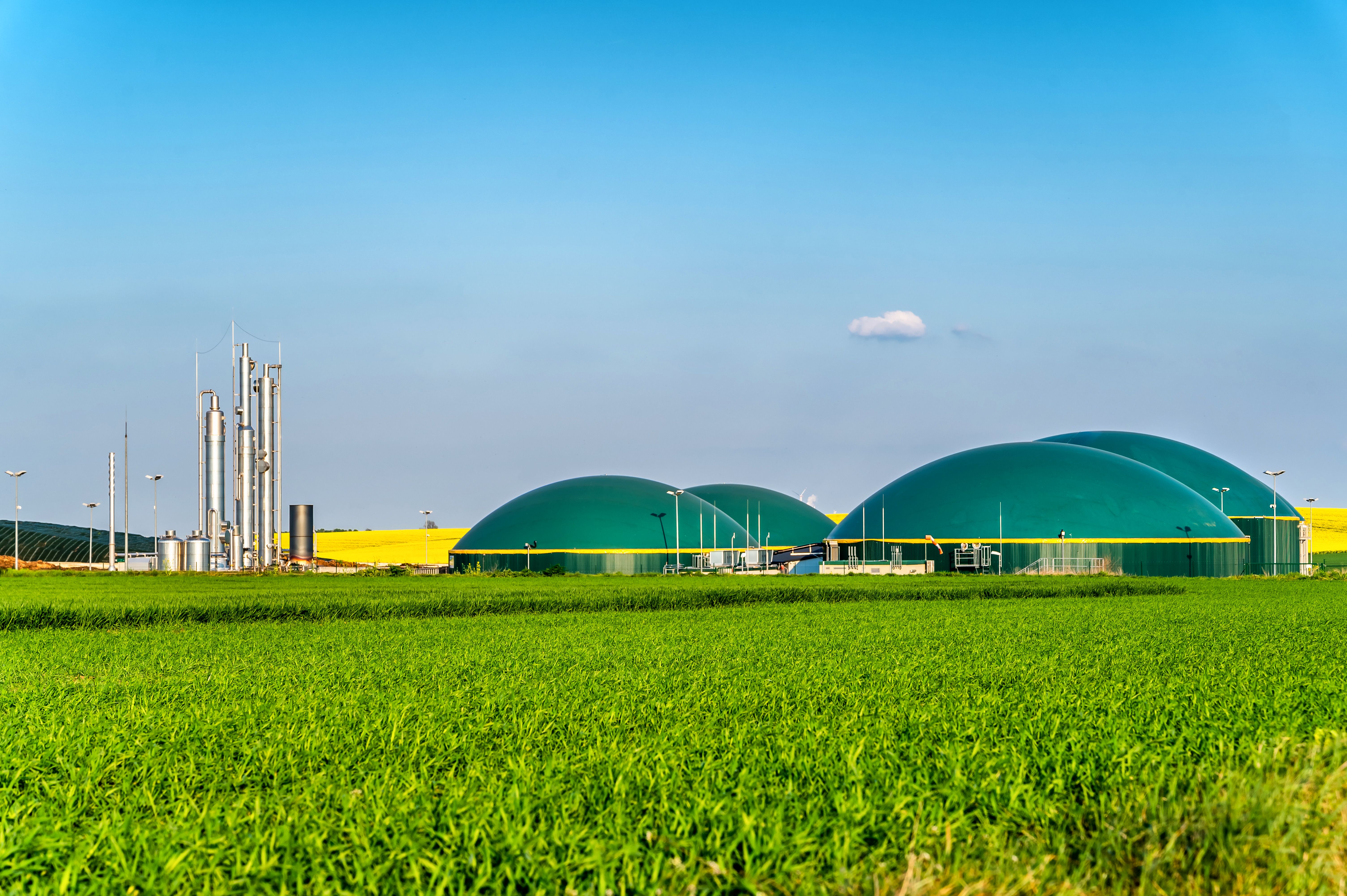 Modern biogas plant between several fields in rural region