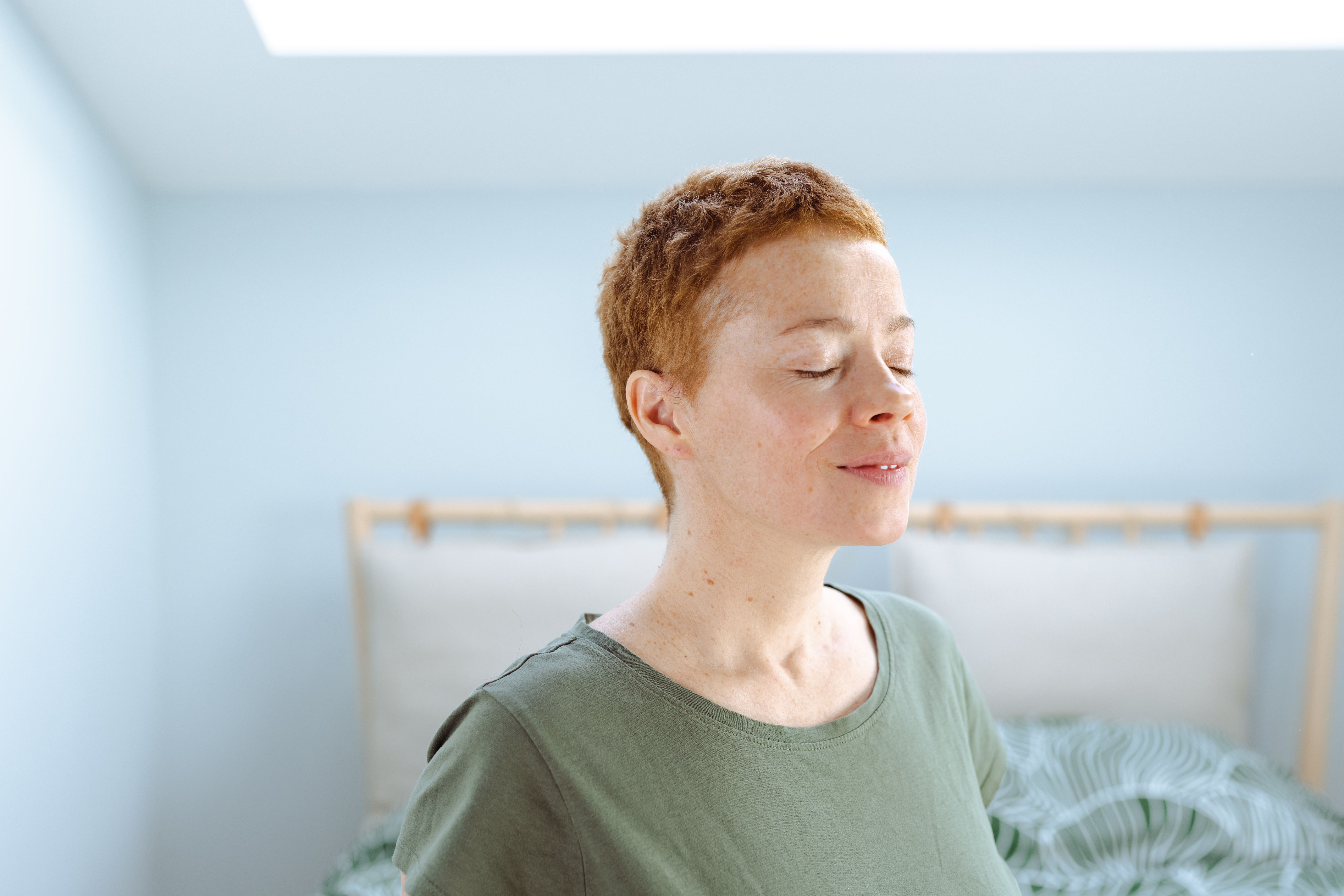 Portrait of mature woman taking a deep breath in the morning