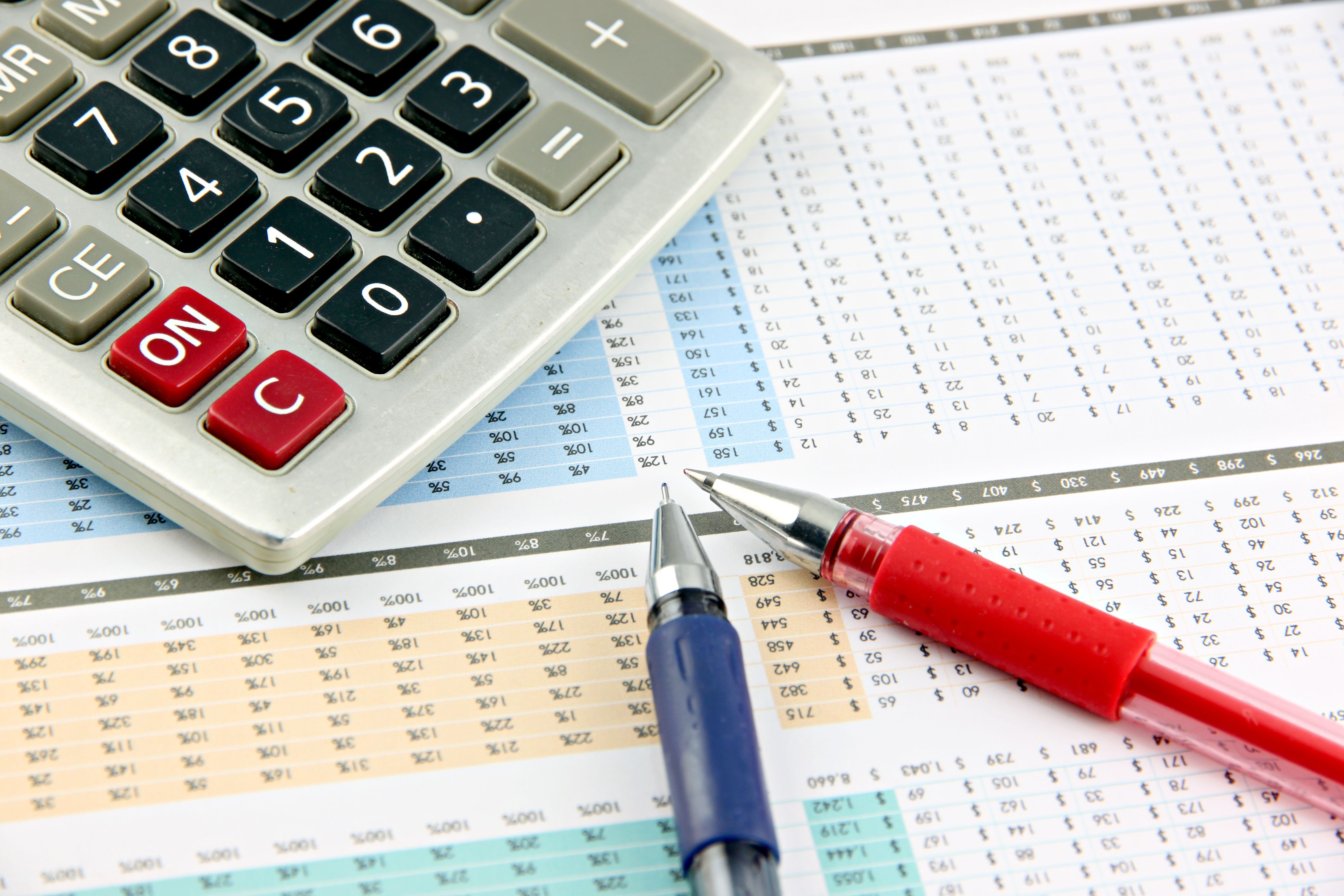 Pen and Calculator that is placed on businesses graph.