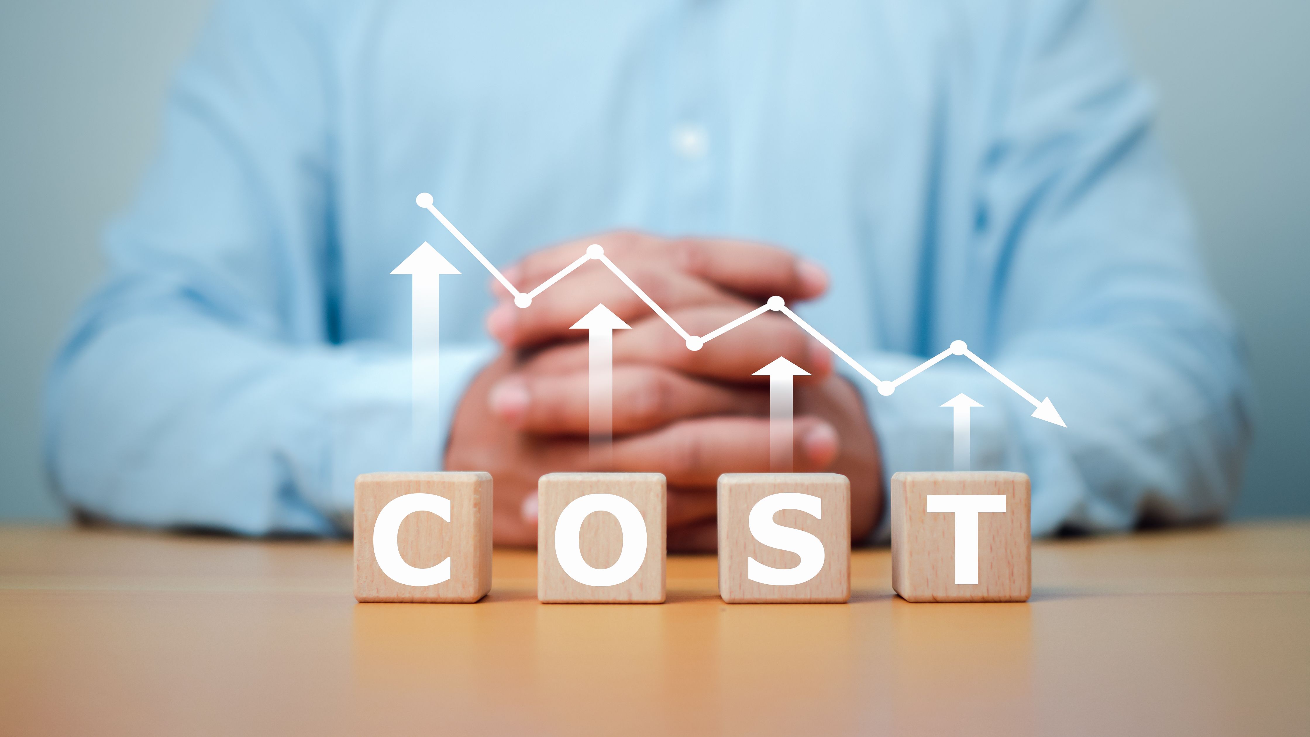 Cost reduction concept. Cost wording on decreasing coins stacking. cost reduction concept which effect to product cost , profit , inflation and economy recession concept.