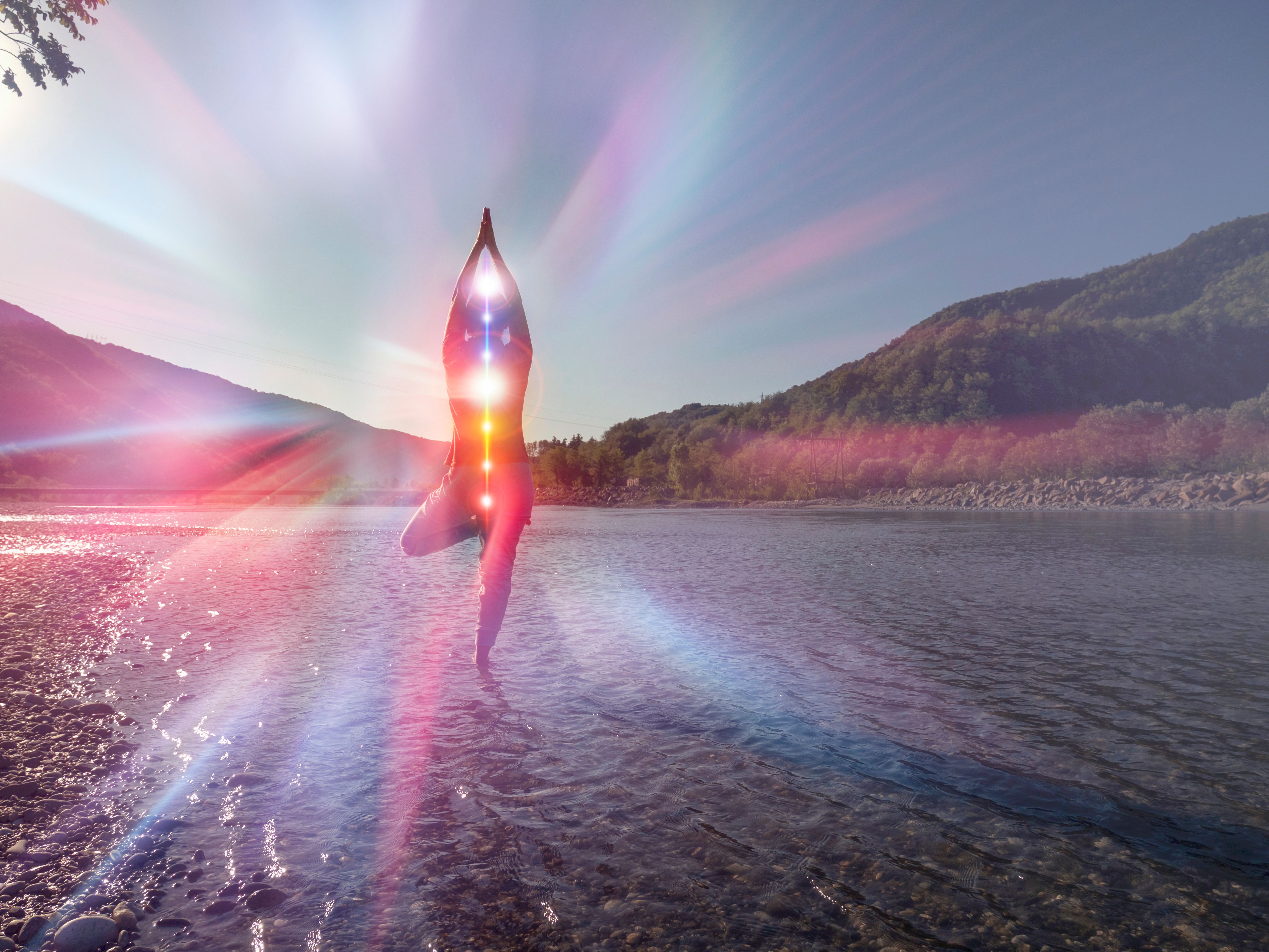 Silhouette of woman in yoga pose on beach sunset view, glowing s Silhouette of woman in yoga pose on beach sunset view, glowing s