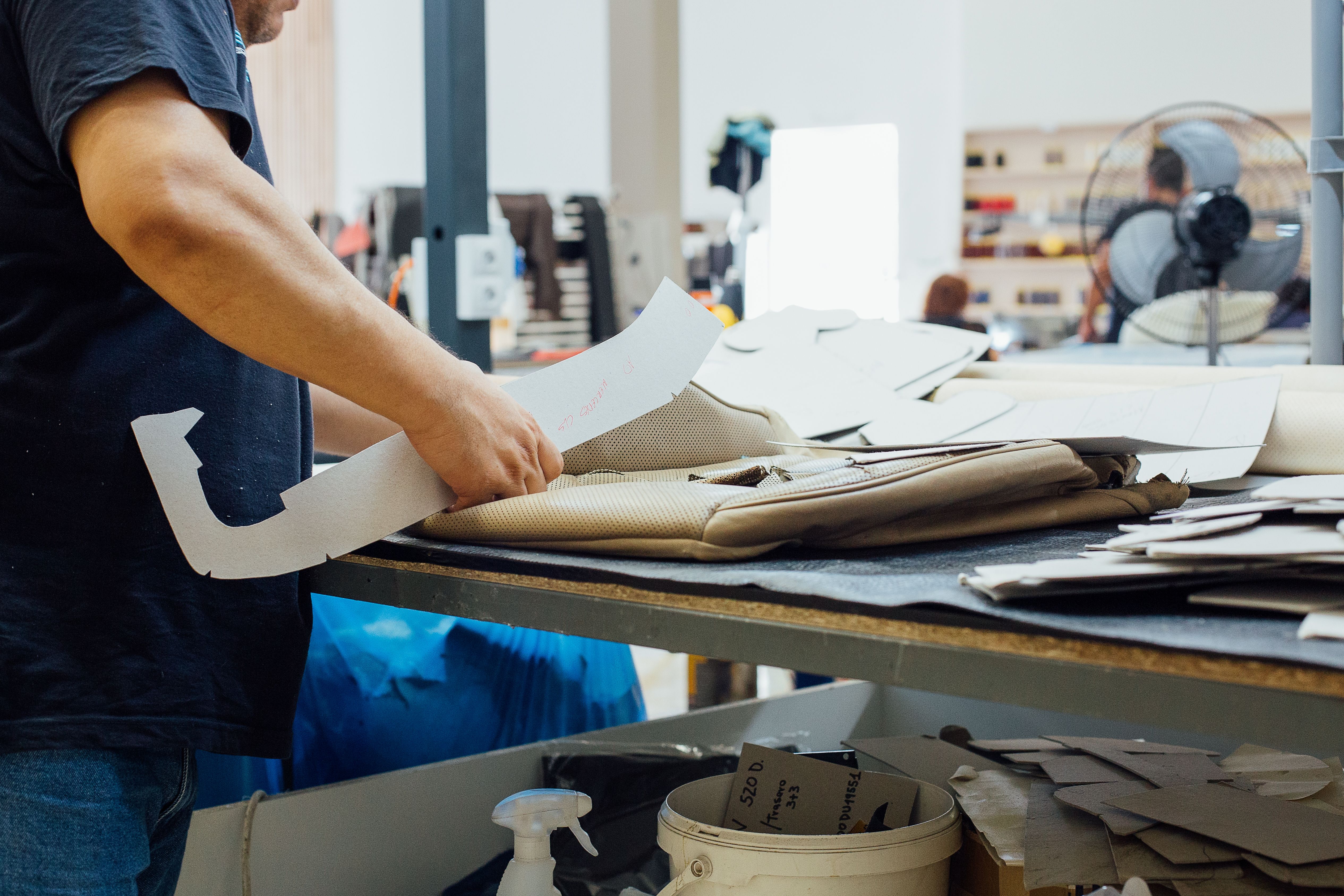 Man works on a upholstery leather factory