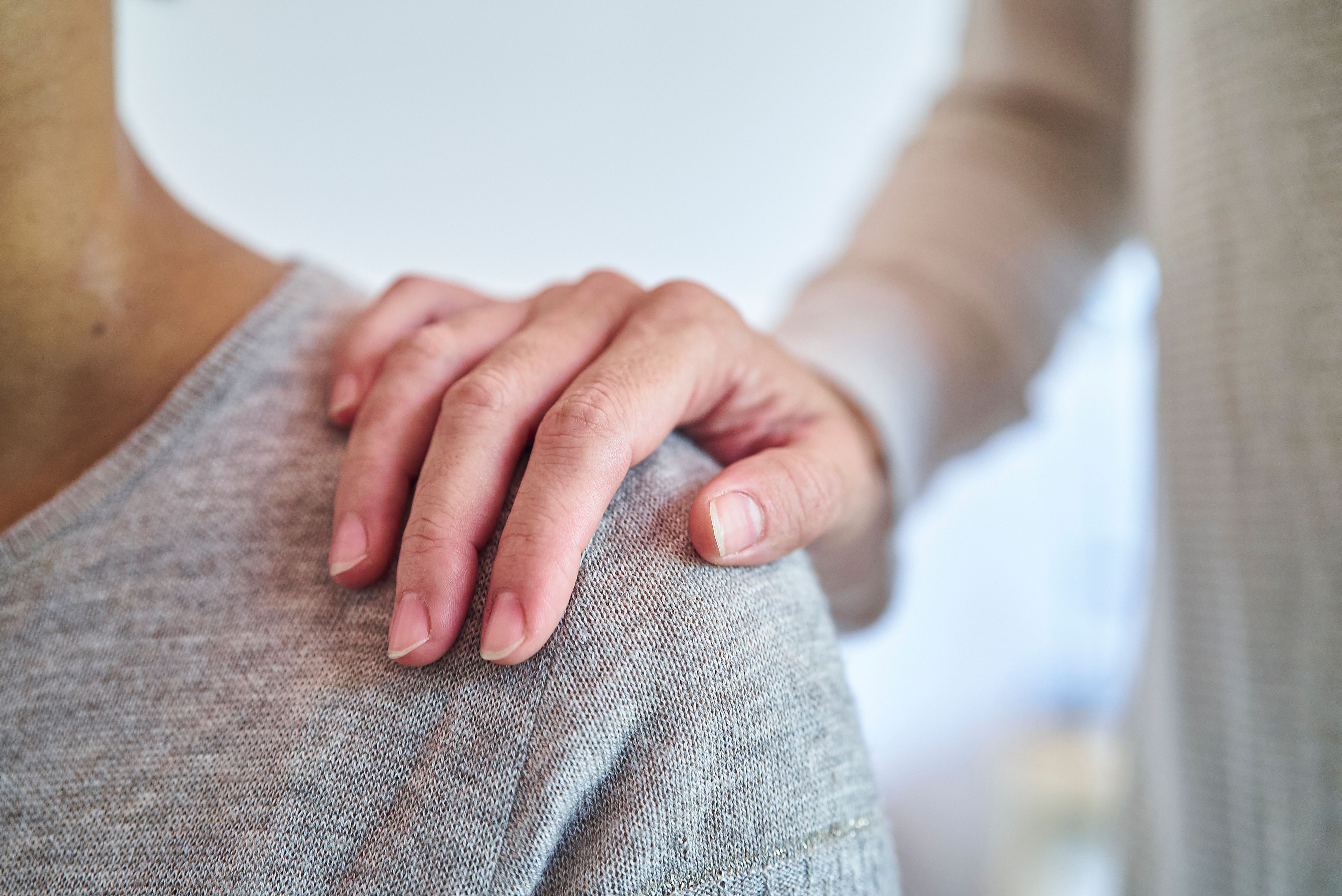 Woman supporting female friend while putting hand on shoulder Woman supporting female friend while putting hand on shoulder