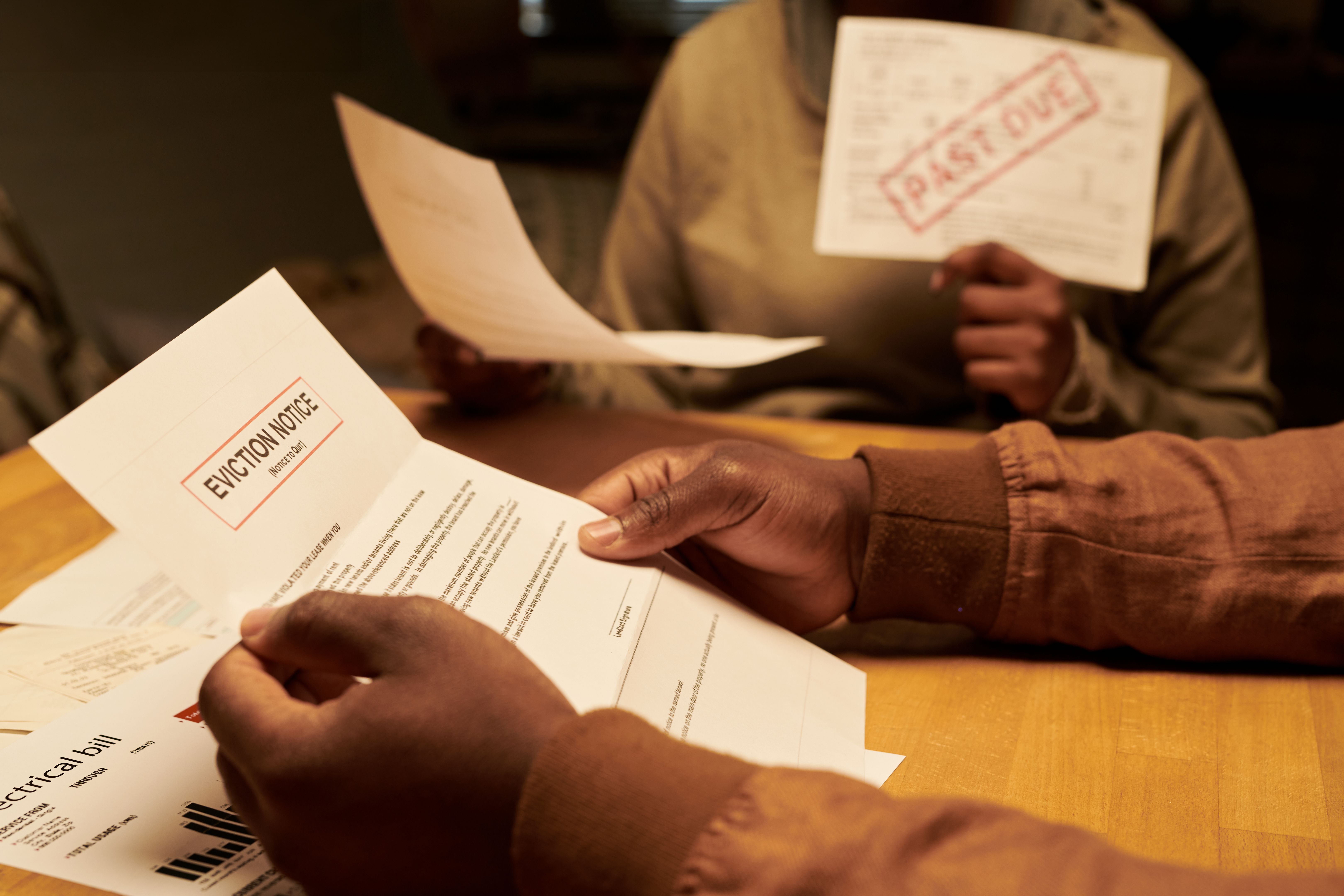 Male hands with unfolded eviction notice