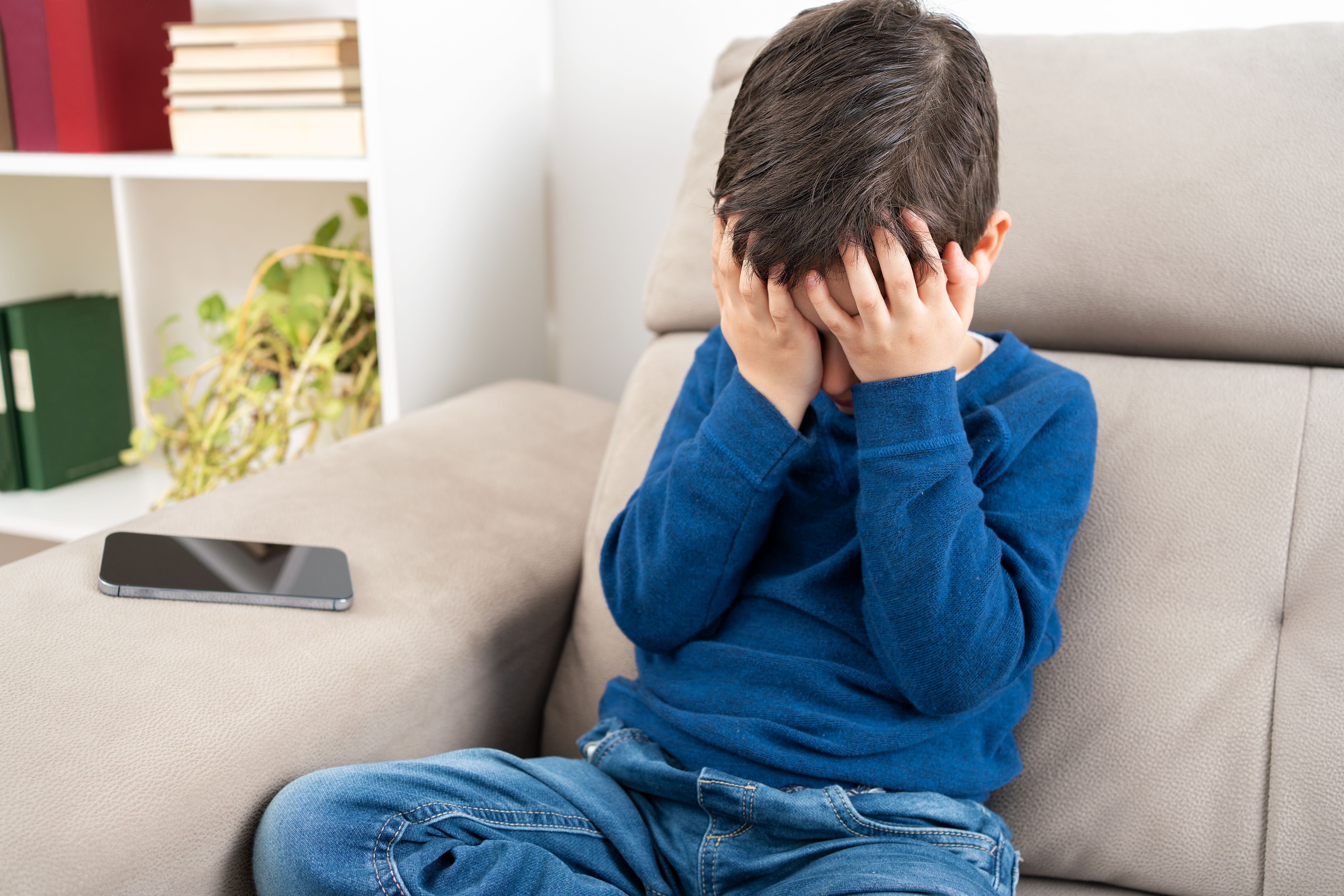 problem child with head in hands