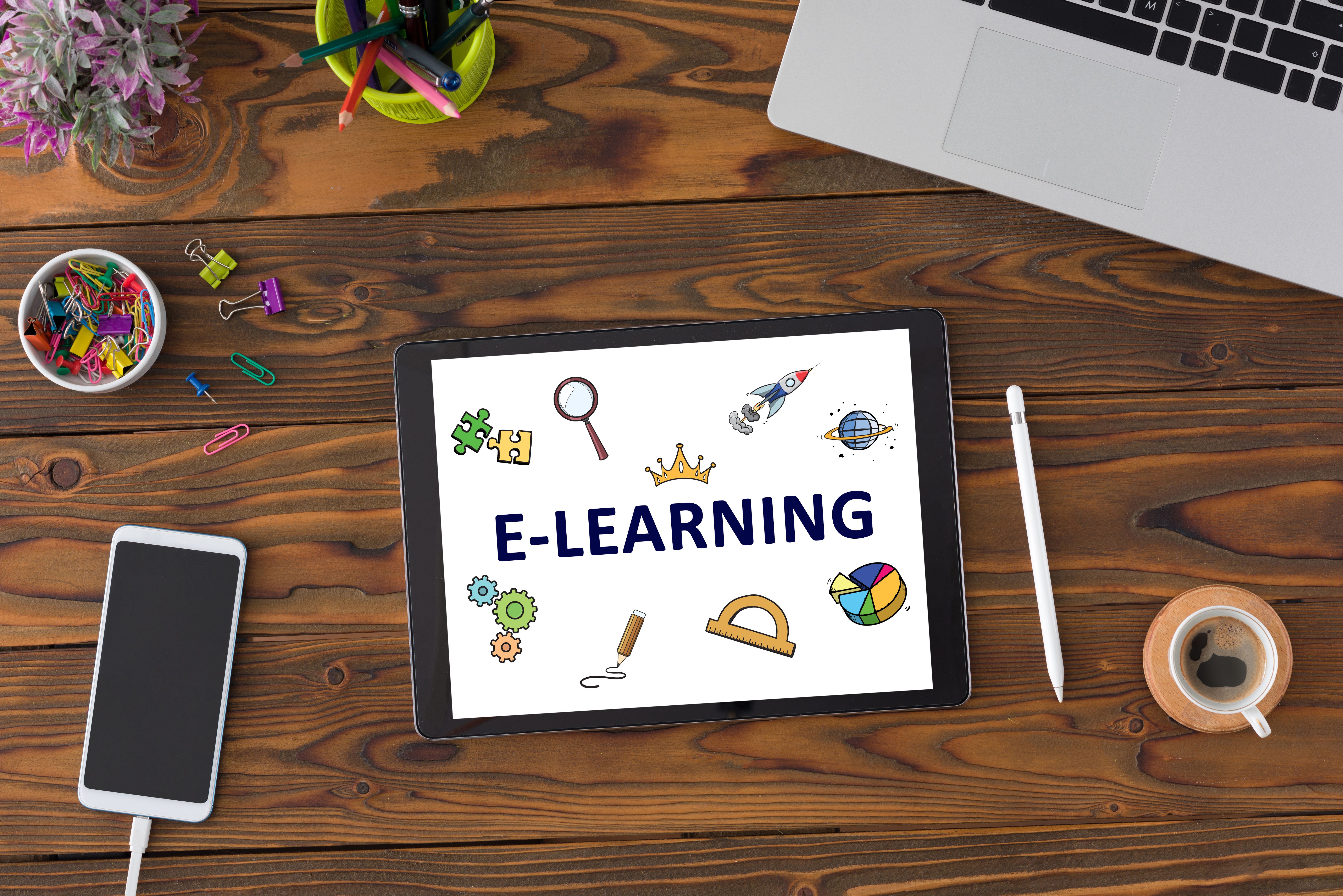 E-Learning Concept With Stationery Supplies, Computer And Digital Tablet On Desk