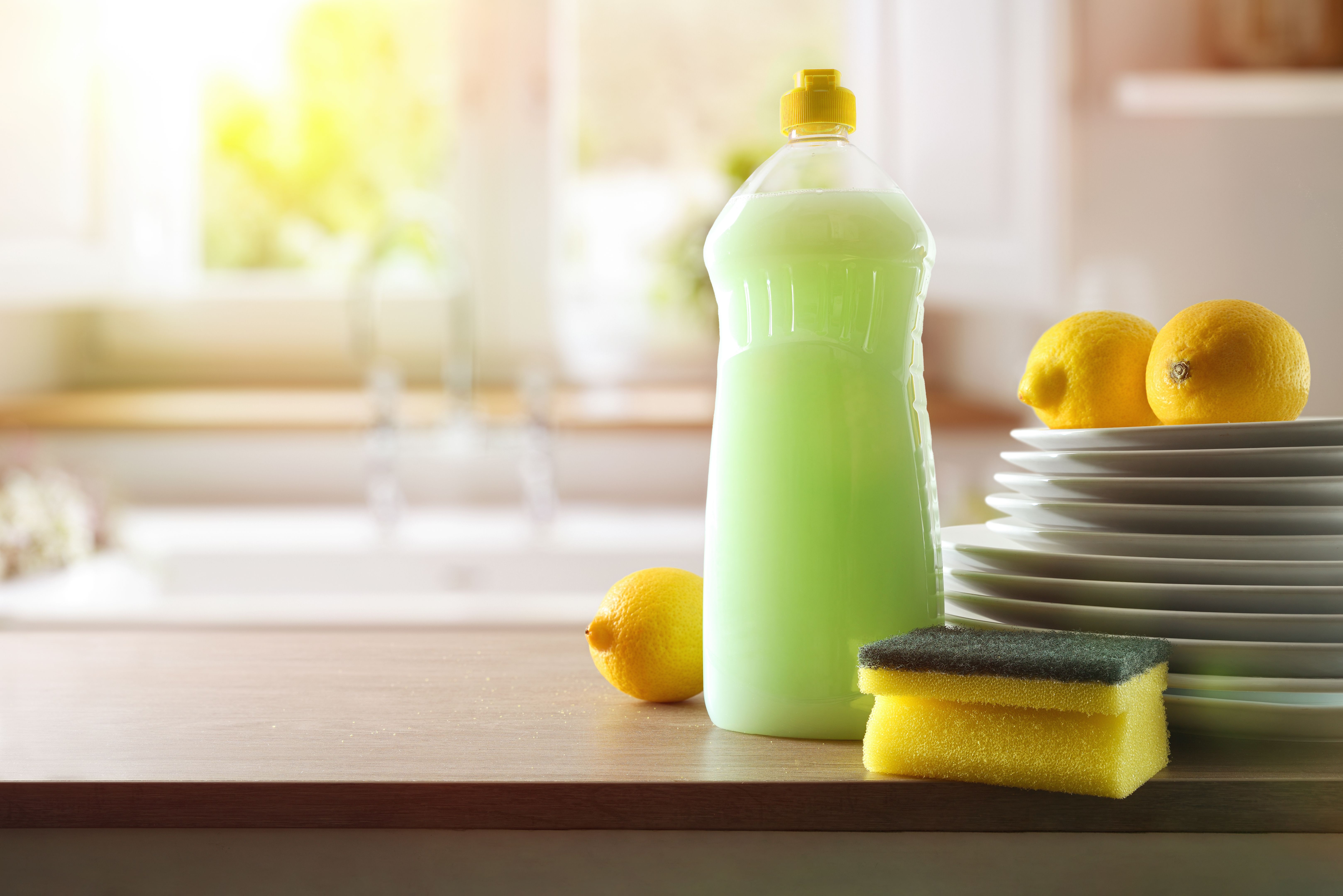 Eco-friendly dishwashing product on wooden kitchen bench with sink