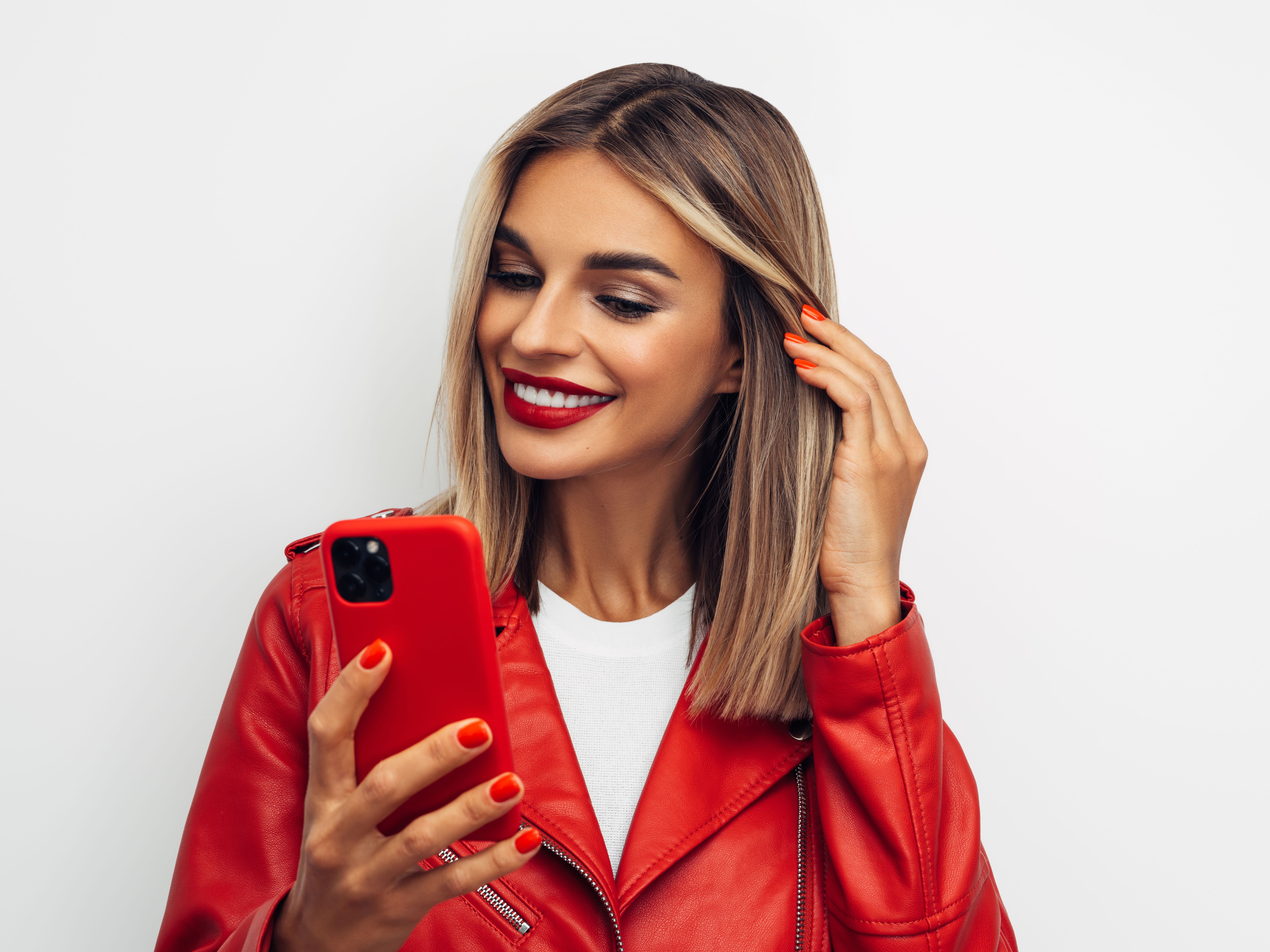 Young happy emotional girl holding a smartphone