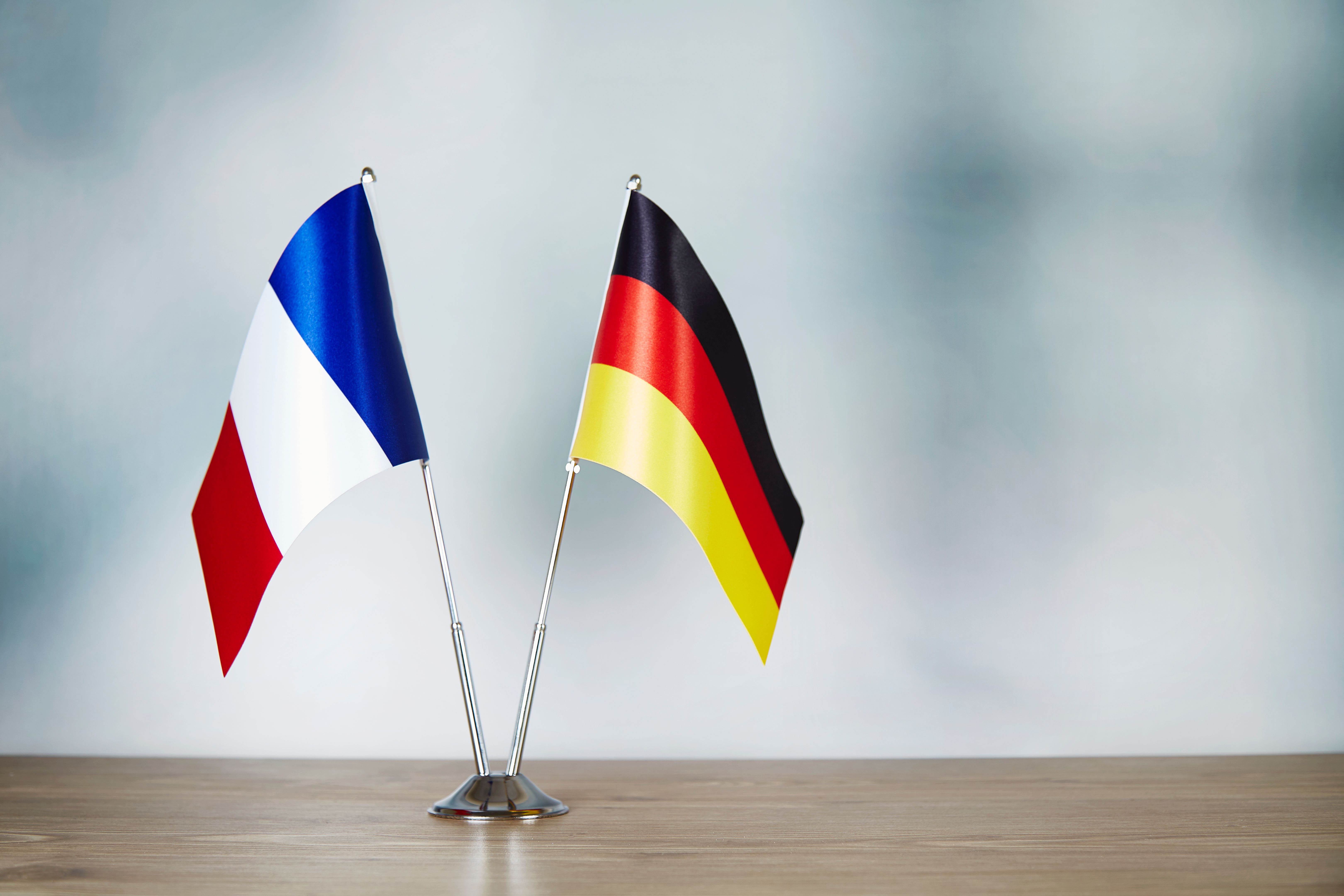 French and German flag standing on the table