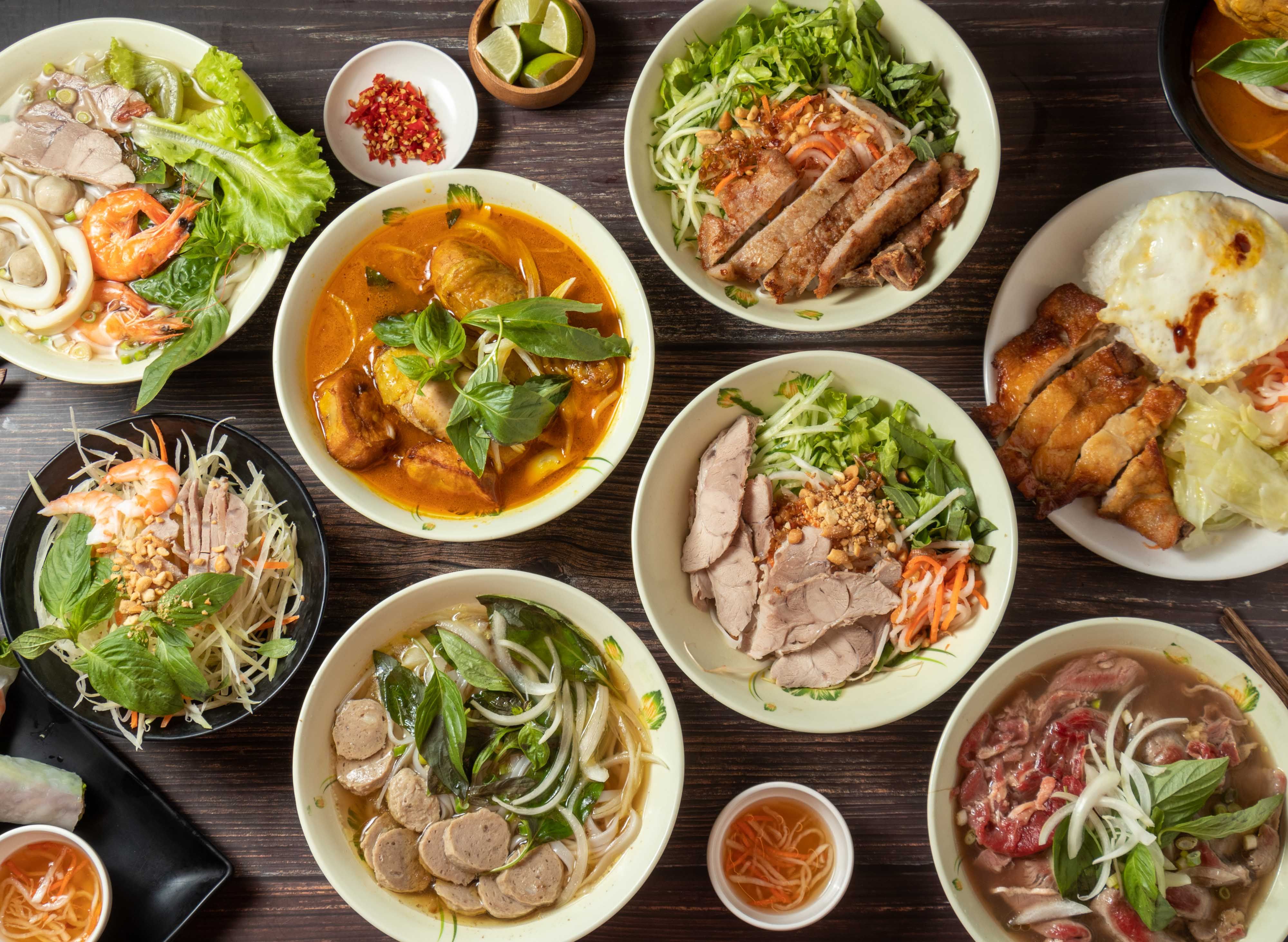 Curry Chicken Hor Fun, Beef Ball Hor Fun, Drumstick Rice, Shredded Papaya, seafood pho, Pork Chops with Vietnamese Rice Noodles, lime and sauce served in bowl isolated on table top view of taiwan food