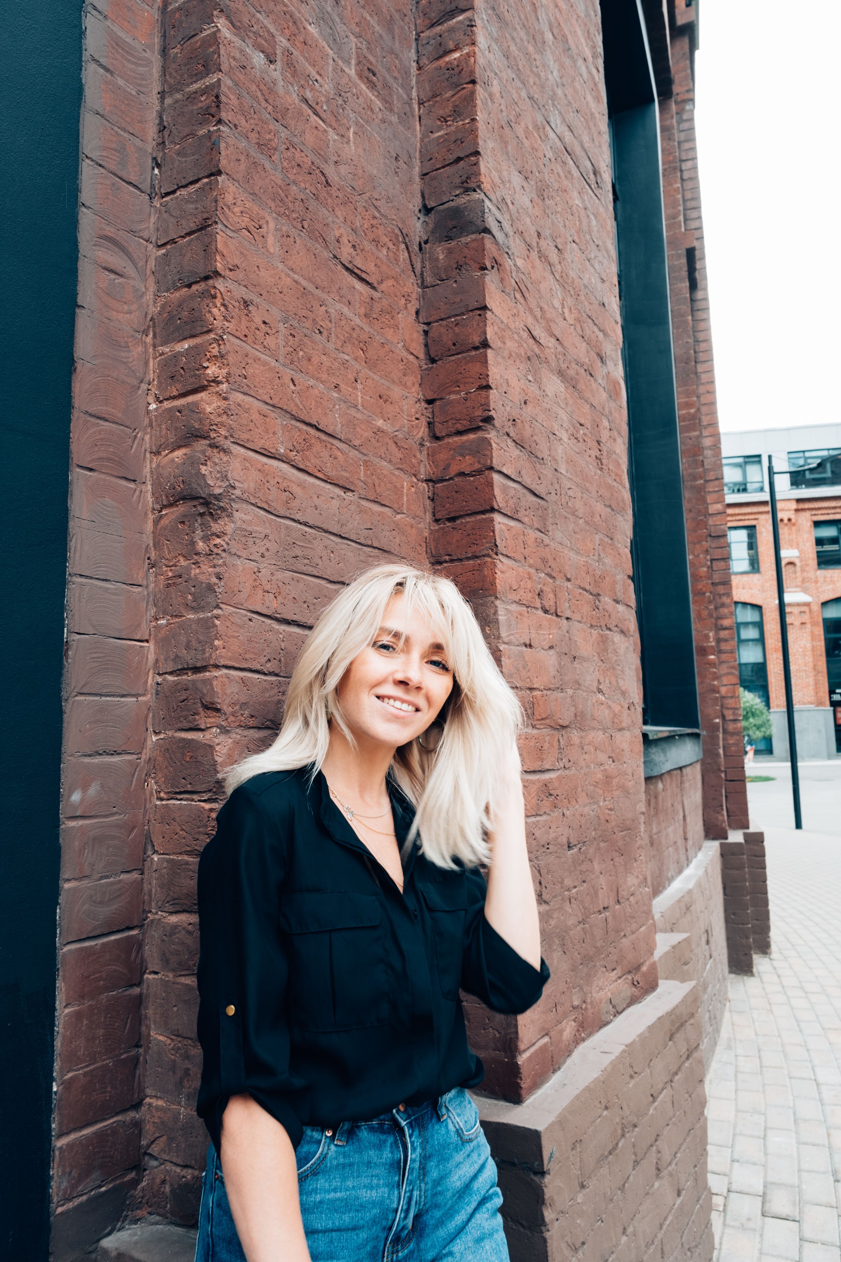 Outdoor portrait of a woman in front of the wall Outdoor portrait of a woman in front of the wall