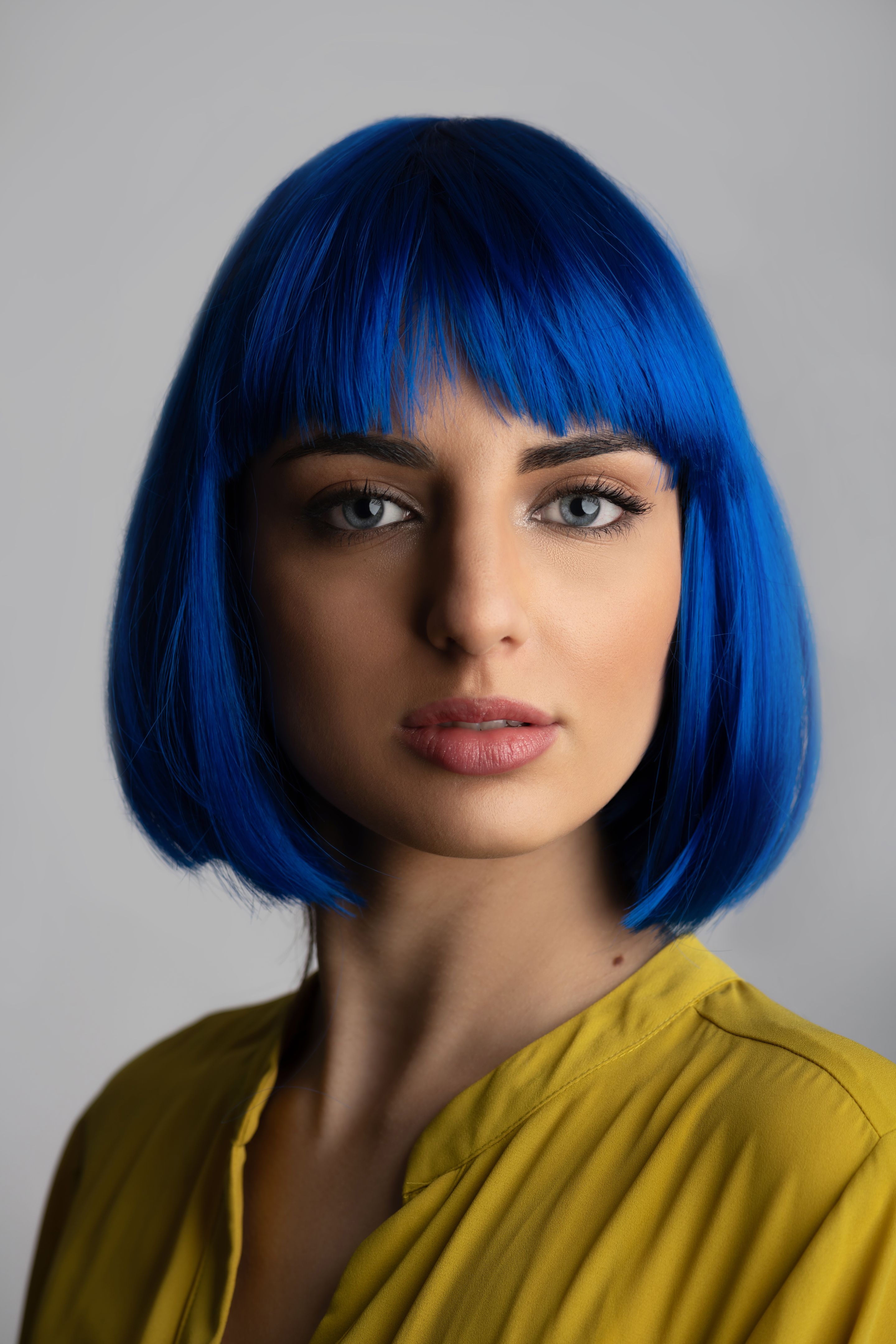 Portrait of beautiful woman in blue wig and yellow t-shirt