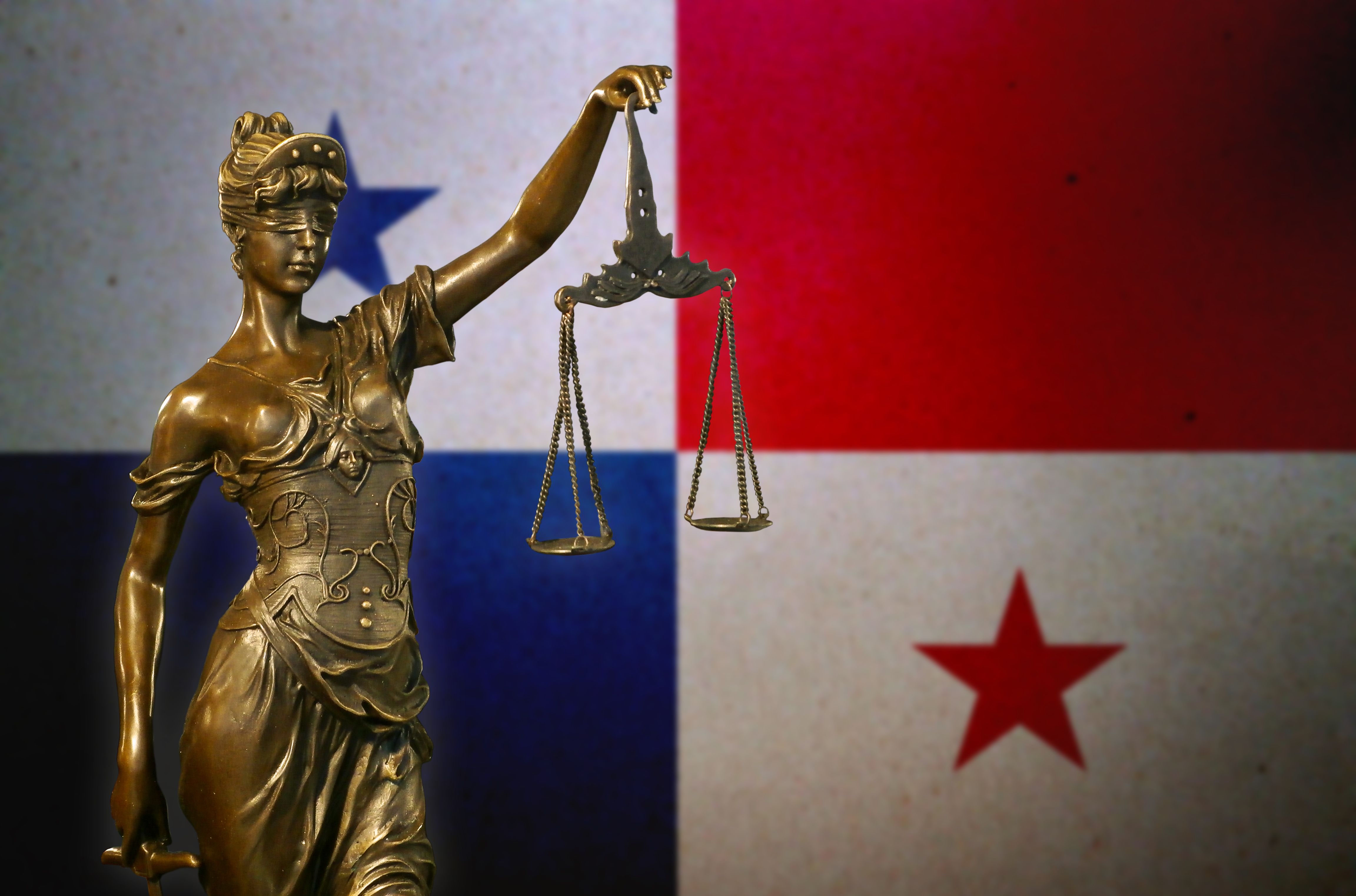 Lady Justice before a Panamanian flag