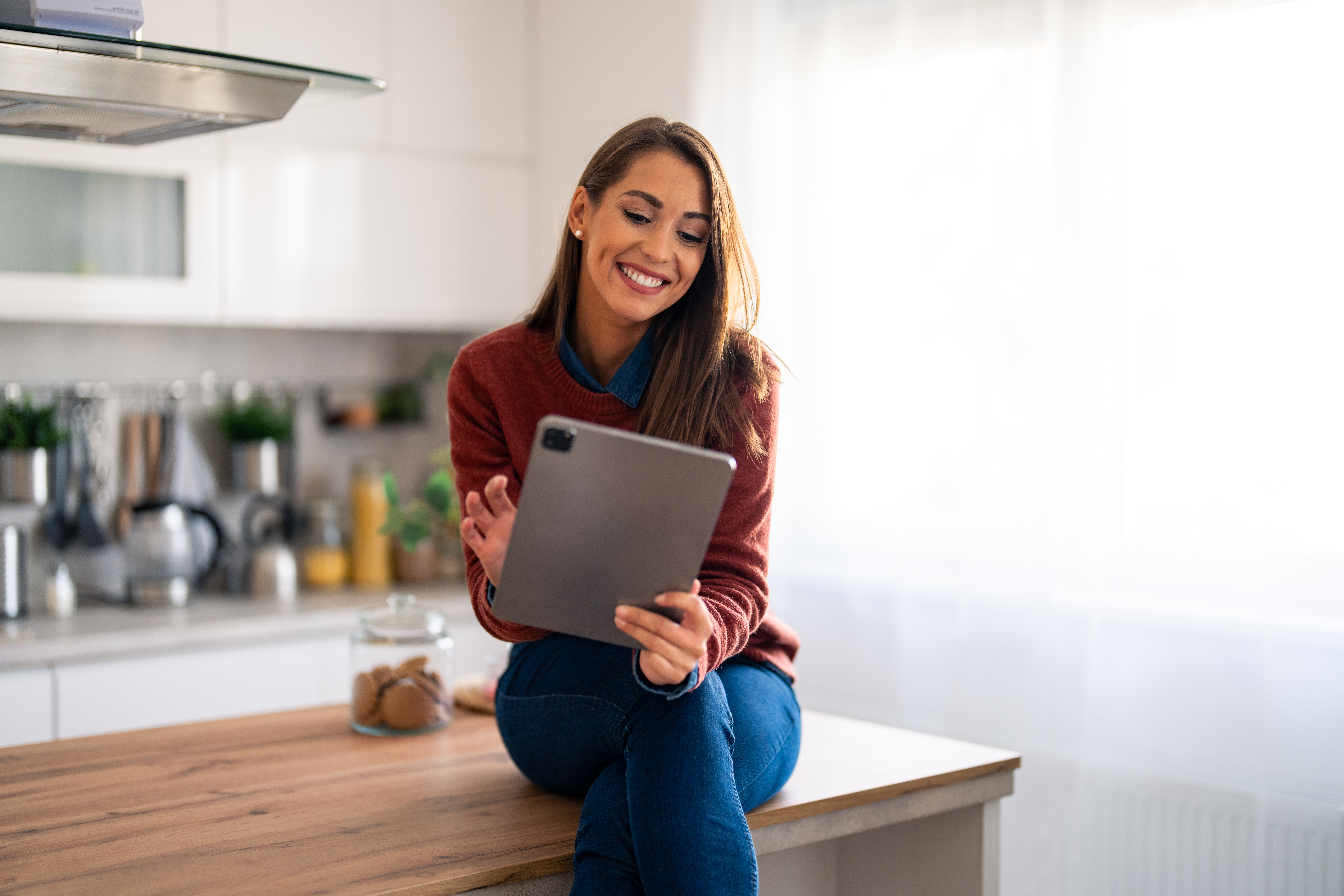Professional businesswoman looking at tablet distantly working from home