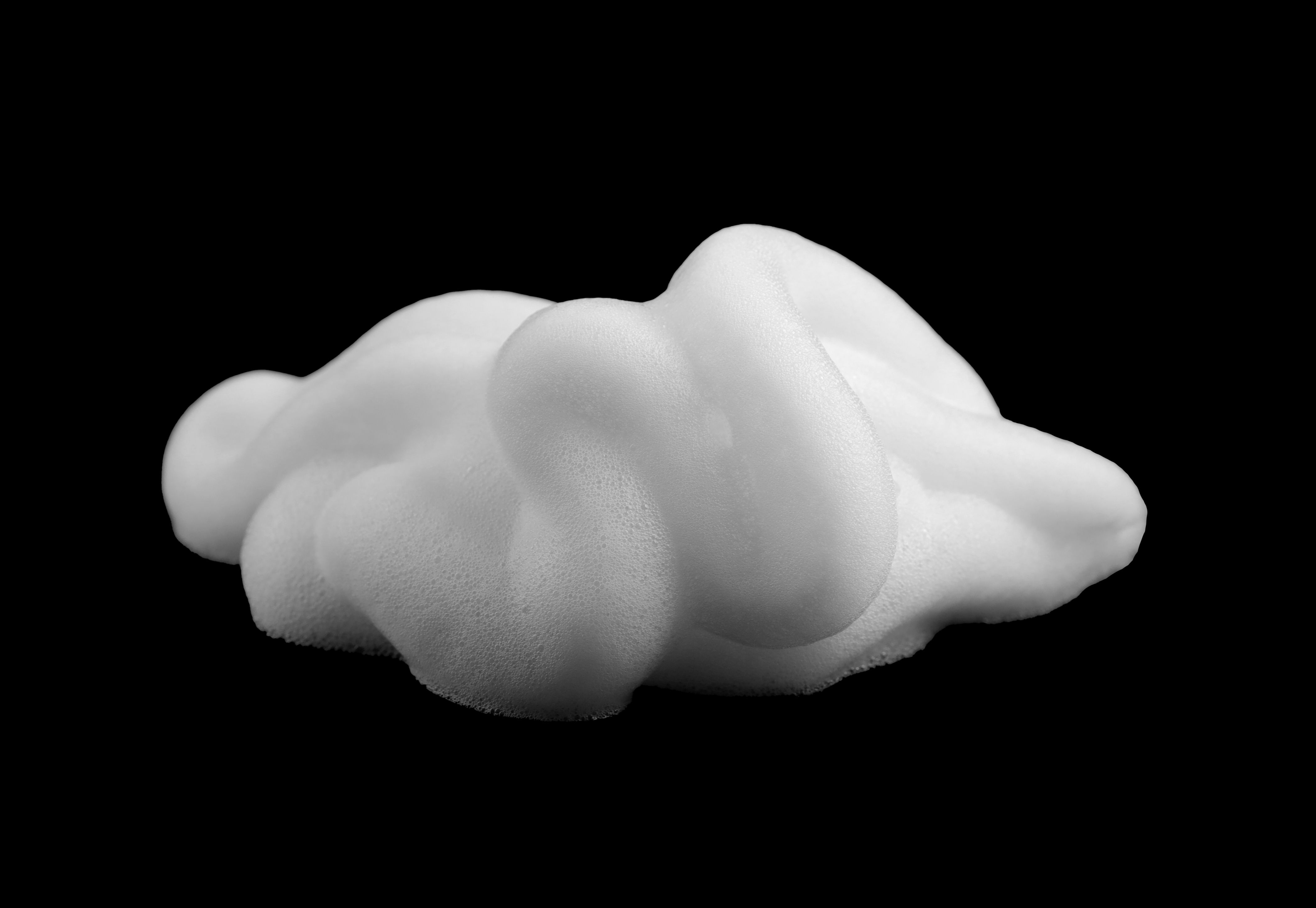 Shaving foam, shampoo or shower gel, black background, textured and contrasting background.