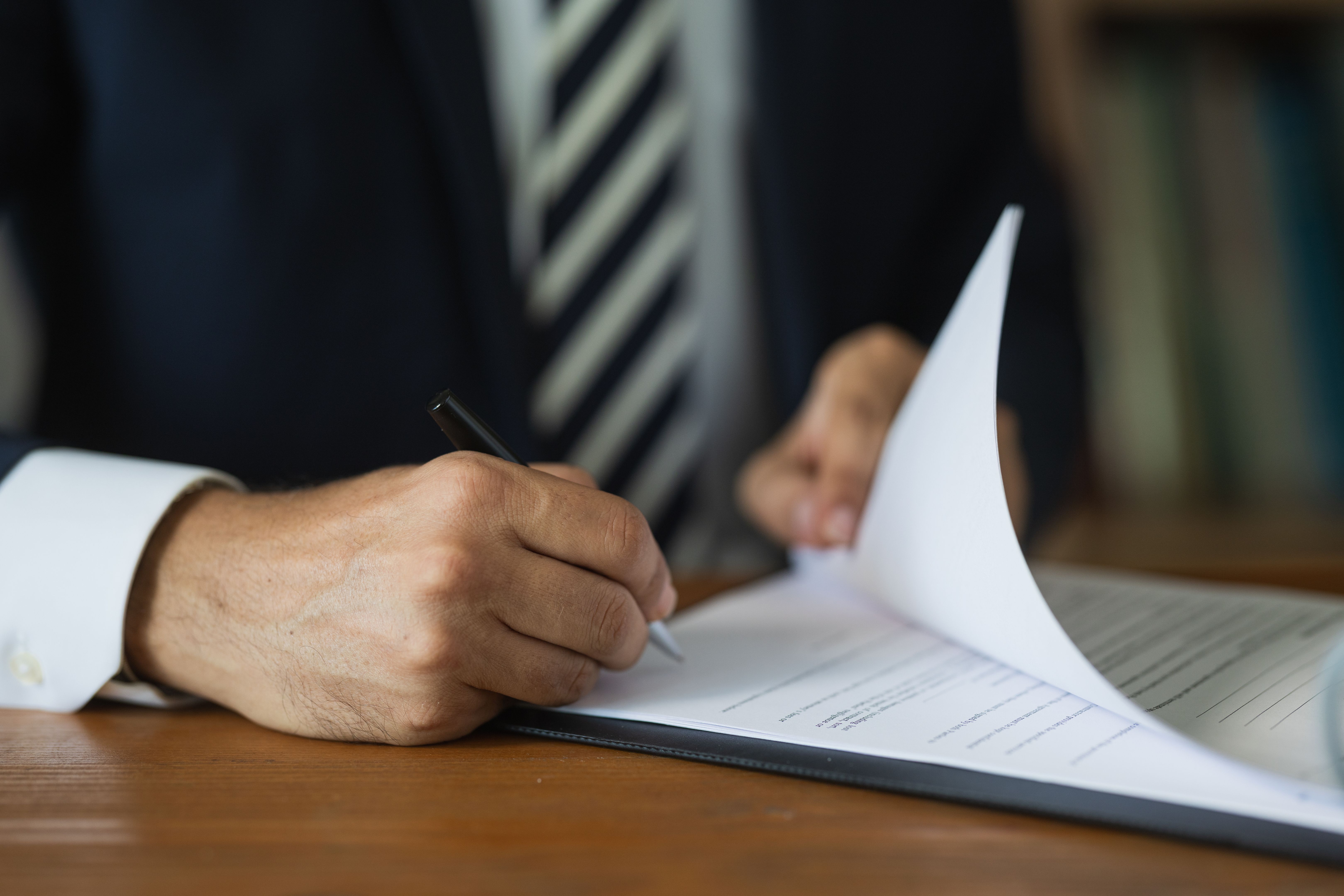 people signing documents