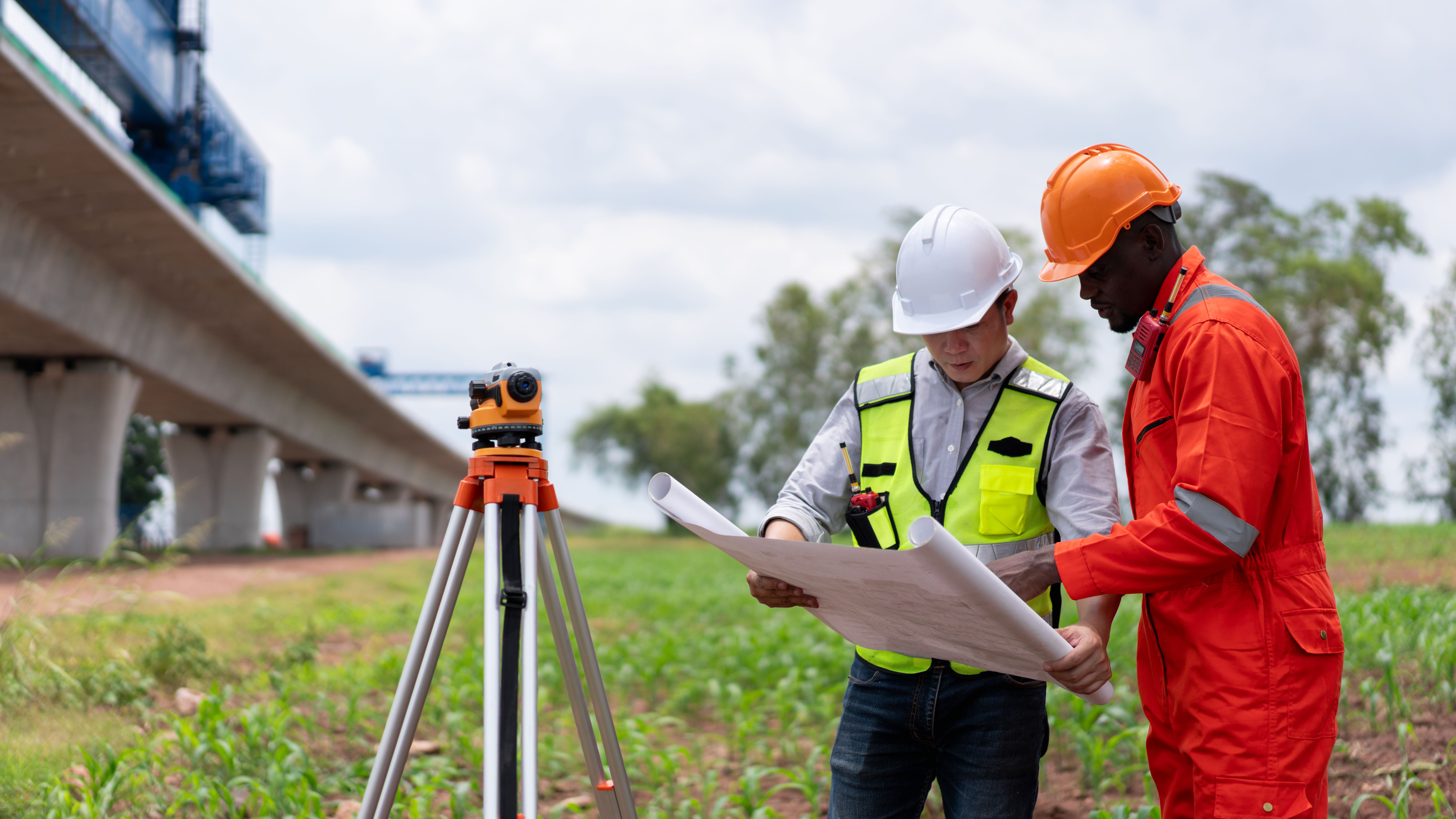 Engineer and field technician reviewing site plans together on a Texas project